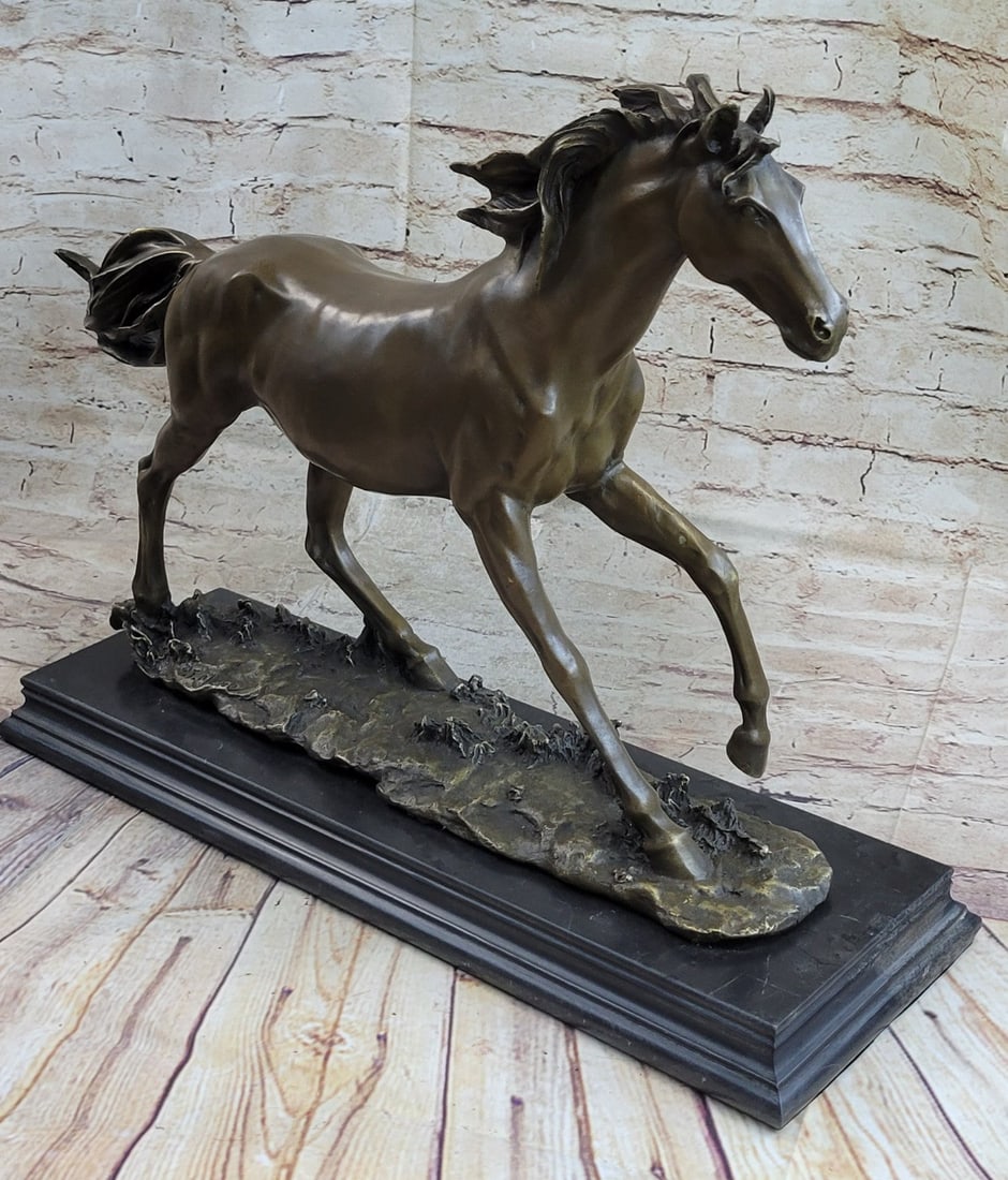 Horse Bronze Statue: A feral horse stands solemnly in the valley. Its hair is quite long indicating his untamed state. The body of the horse is lean. This simple sculpture is ideal for equestrian or horse lovers and