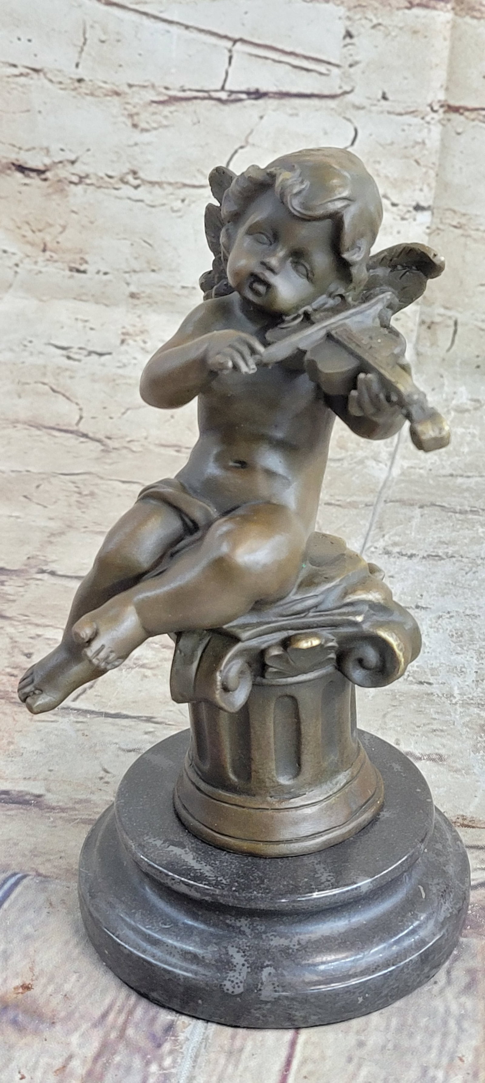 Little boy angel playing Violin Bronze Sculpture: This beautiful bronze statue depicts an adorable little cherub playing the Violin. It is part of a series of cherub musicians and would look equally good inside your house or in your garden. The