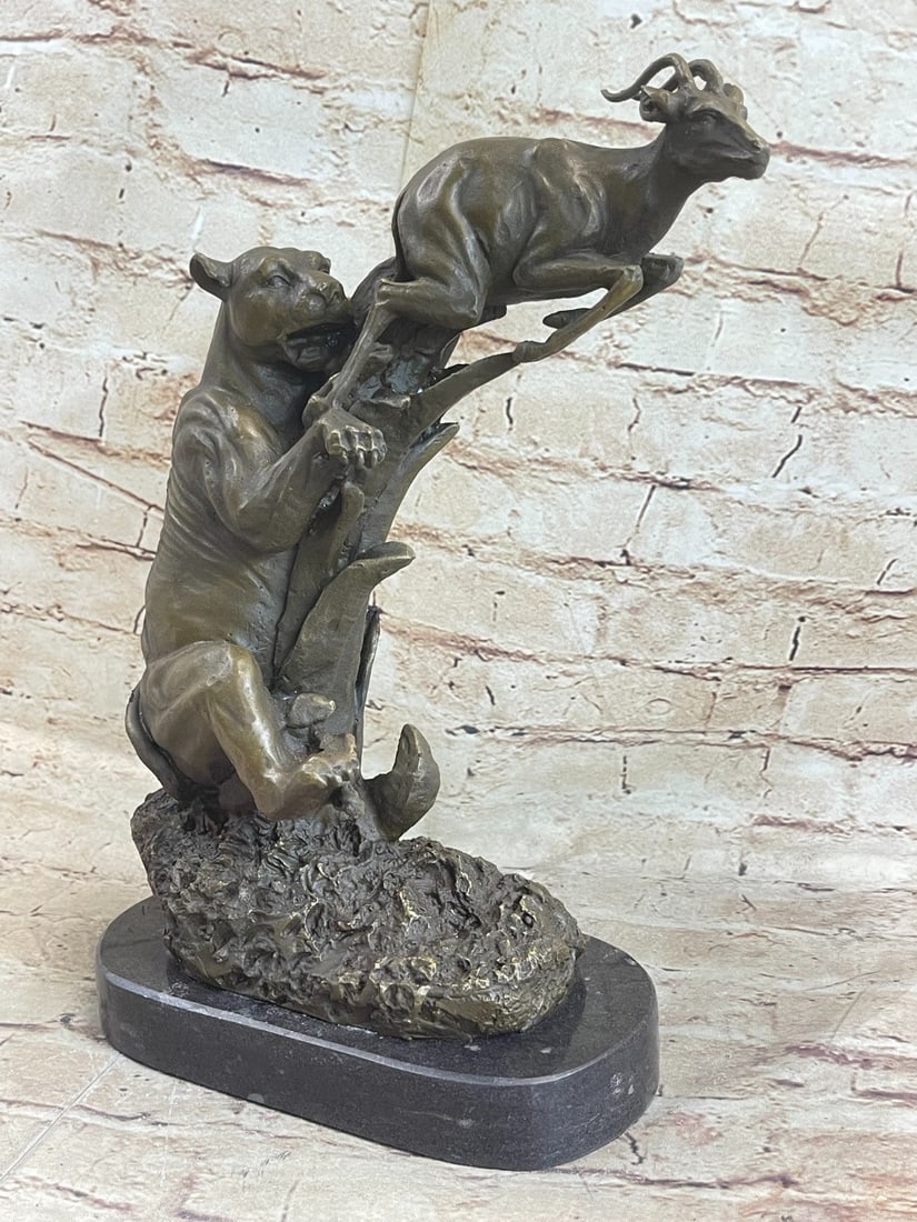 Jaguar attacking Bronze Sculpture: This jaguar was lurking in the shadows of his play field and spotted his meal of the day. The baby deer starts to run for his life, but knows their is no hope for him, he is the jaguar's dinner