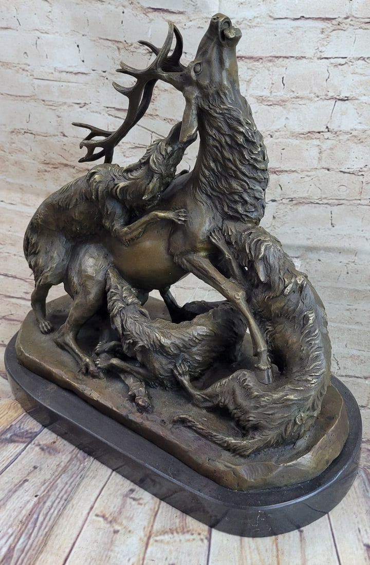 Elk Fighting Pack of Dogs Wild Life Bronze Sculpture: A brave Elk is forced to defend himself against a pack of wild dogs eager to tear him to shreds. The canines have the Elk surround biting at his body from every angle. He has his head bend utilizing h