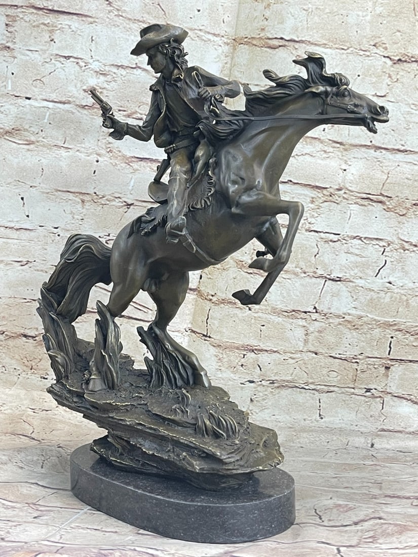 Cowboy with Gun Riding Horse Bronze Sculpture: The outlaw in the wild west holds the reigns tight, twists back, and fires a gunshot to his enemy that is closing on his tail. He appears steady on the fast-moving horse. This bronze sculpture pays
