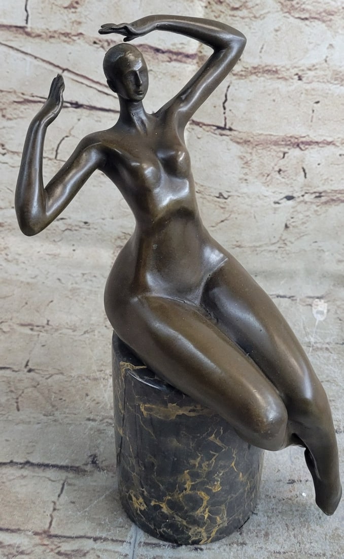 Nude Girl Bronze Sculpture: The voluptuous woman rests elegantly on the olive green marble base. The artist accentuated her hips and thighs. Her waist appears much smaller in comparison. Her arms are raised with one palm