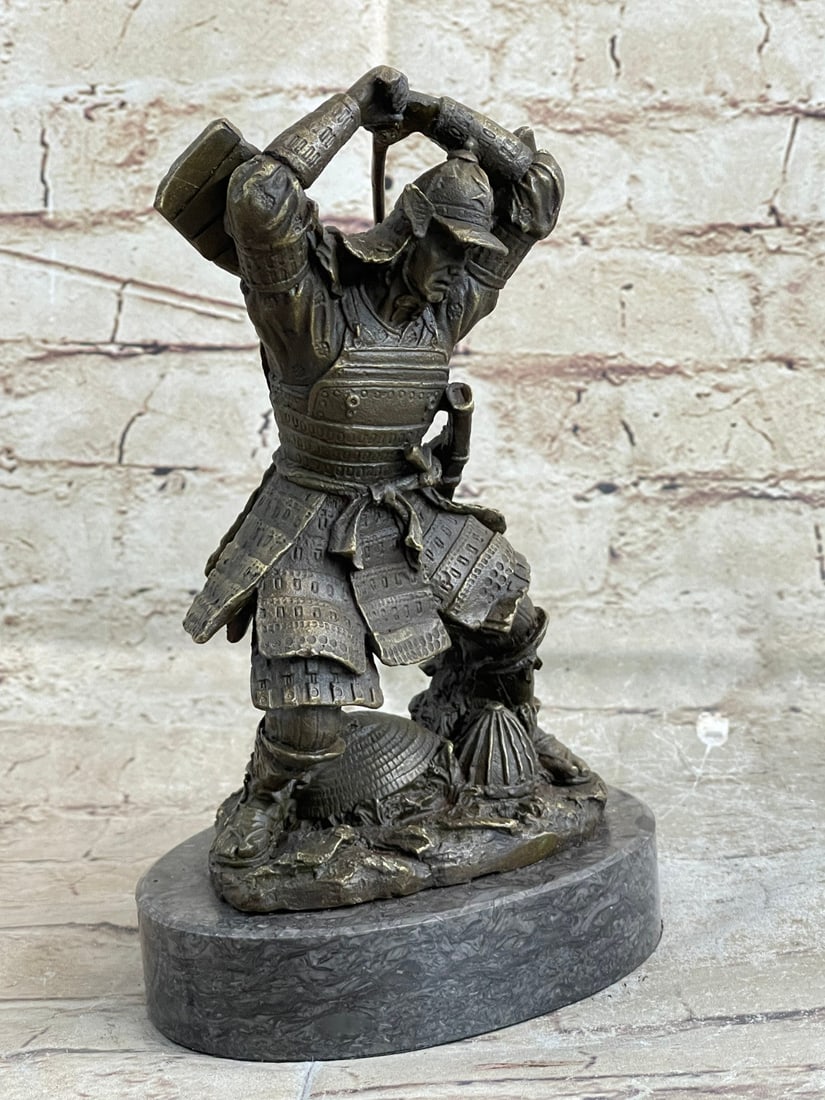 Samurai Bronze Figurine: He is about to take his first swing to protect his people and his honor with his sword pulled over his head and knees bent in preparation. The warrior has on traditional samurai gear from the helmet