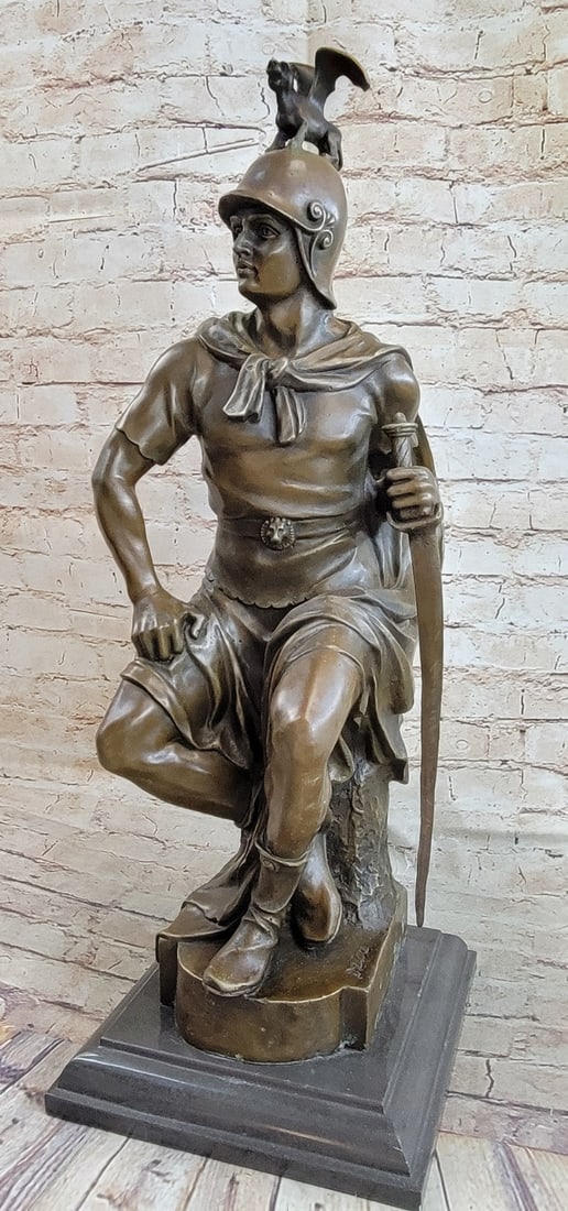 Ancient Greek Emperor Bronze Sculpture: This Ancient Greek emperor sits up straight and proud as his portrait is chiseled out for him. He wears his full royal armor and holds his sword displaying it proudly. His helmet covers right to his