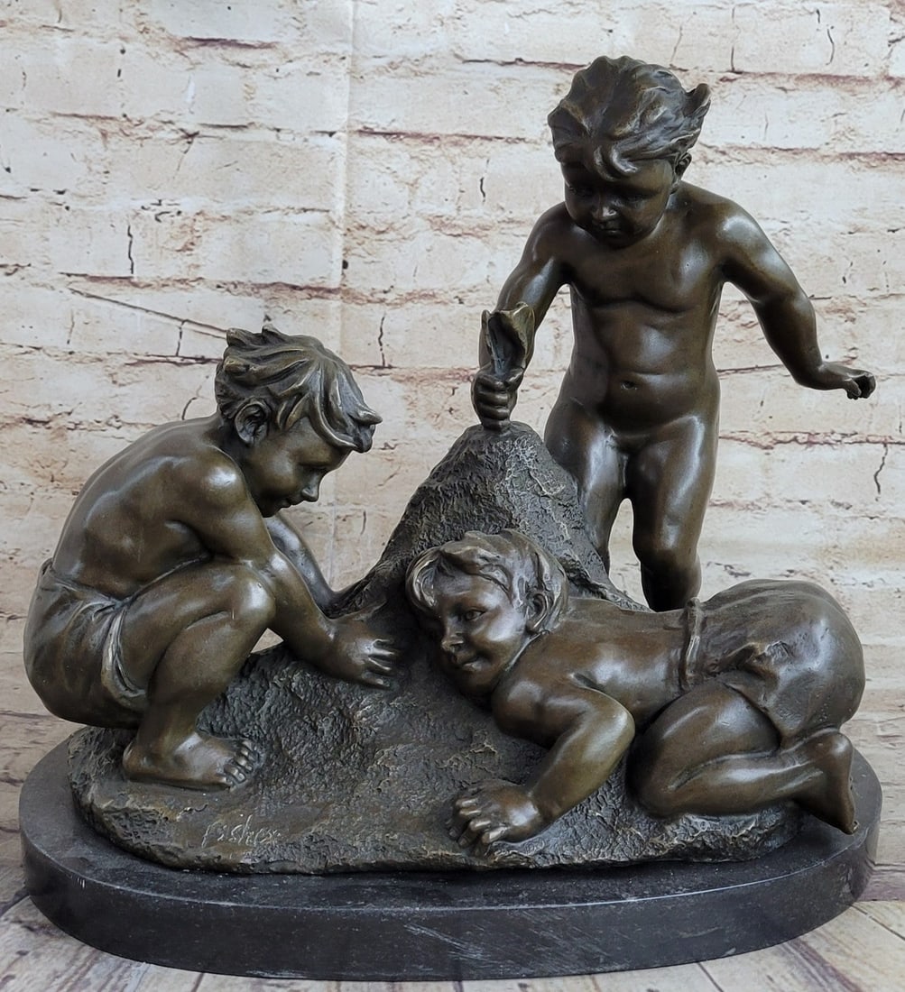 Bubbly Toddlers play in Sand Bronze Sculpture: Three bubbly toddlers play in the sand. They are creating a sandcastle. Their young friendship is blossoming. One child stands and places a flag at the top of the sandcastle as the others gather sand 