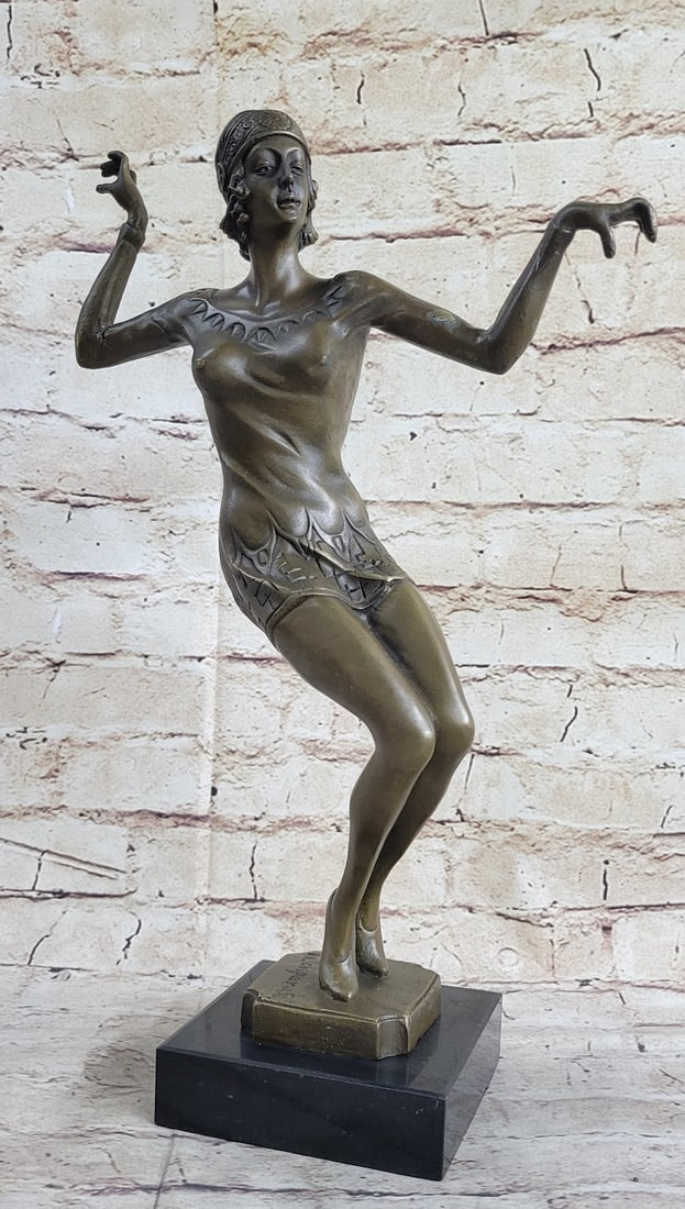Art Deco Bronze Sculpture: The skilled dancer balances on her toes, artistically placing her arms in the air. Her body twists demonstrating her agility further. She is dressed in a short dress revealing toned leg muscles. A sma