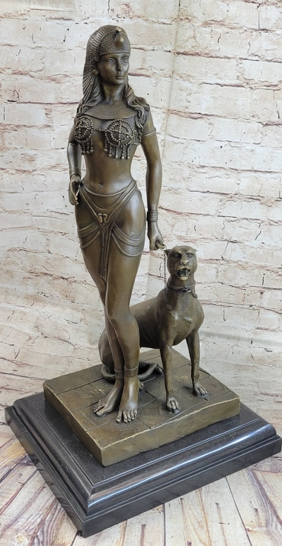 Nude Queen with Lion Bronze Figure: This beautiful sculpture of an Egyptian Queen is gorgeous and has amazing details. She stands in a very sexy position and she wears a little skirt fitted tightly to her waist and thighs. She is bare f