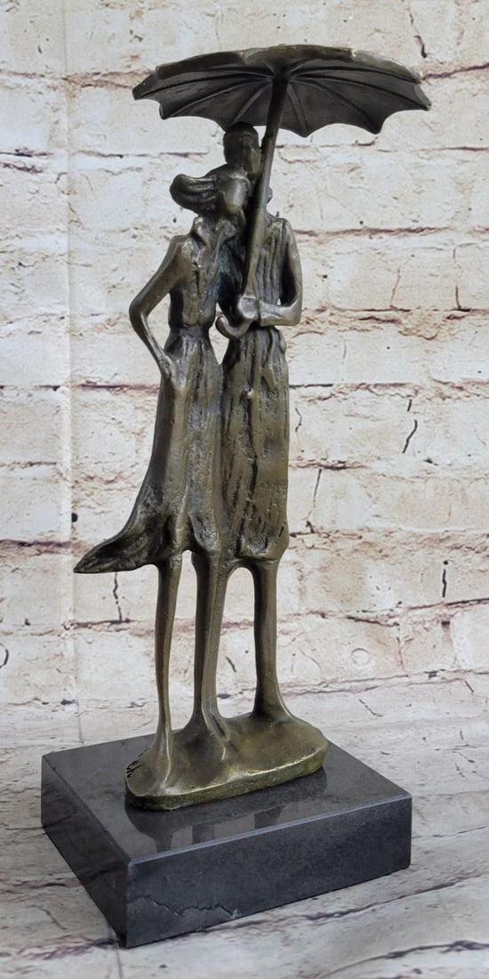 Two Lovers in Rain Bronze Sculpture: Two Lovers share an umbrella and keep each other warm and snug in this sweet sculpture. Exquisite detail and a rich real bronze enhance the distinctive appeal of this piece. This brown patina sculptur
