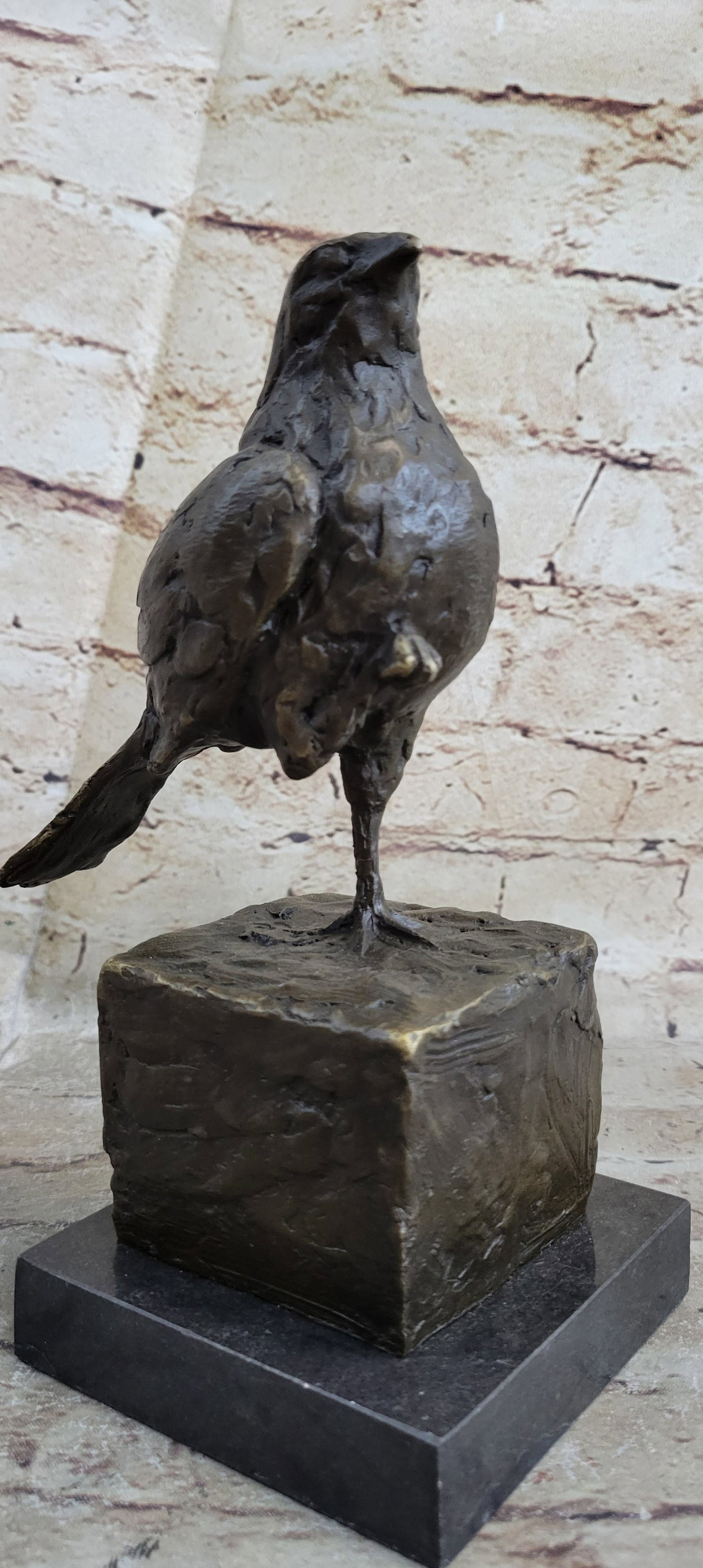 Pigeon Bronze Sculpture: This Bronze piece was crafted using the Lost Wax Method and coated with brown patina highlights of gold. The gold highlights give dimension to the sparrow and draw attention to the detail of the feath