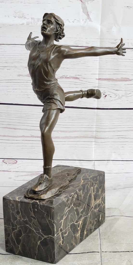 Track Runner Modernist Bronze Sculpture: A speed Runner poses for a portrait. He stretches his long muscular body. He kneels and curls an arm backward. Like a classic pinup, he pushes his chest out, tilts his head up and is ready for his