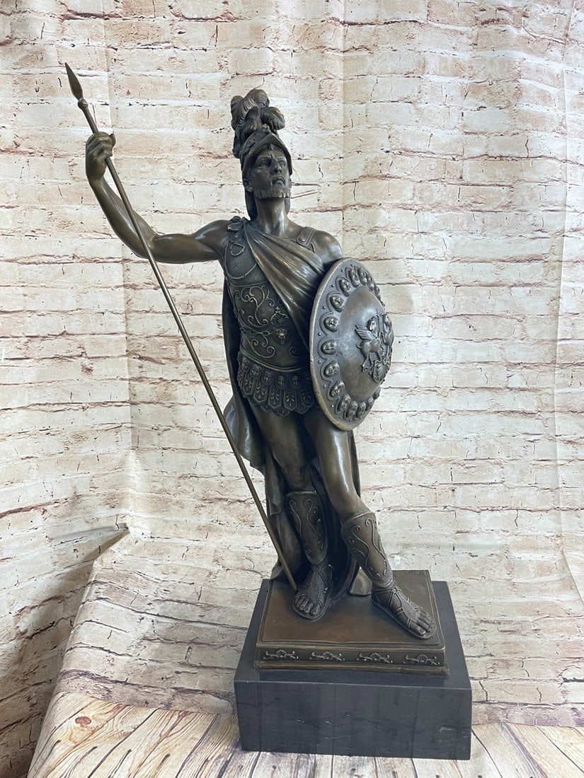 Roman Knight with Armor Bronze Sculpture: The Roman knight stands proudly with his armor and weapons in hand. His confidence radiates in his comfortable stance and tense muscles. A long spear is in one hand and his shield in the other. He is