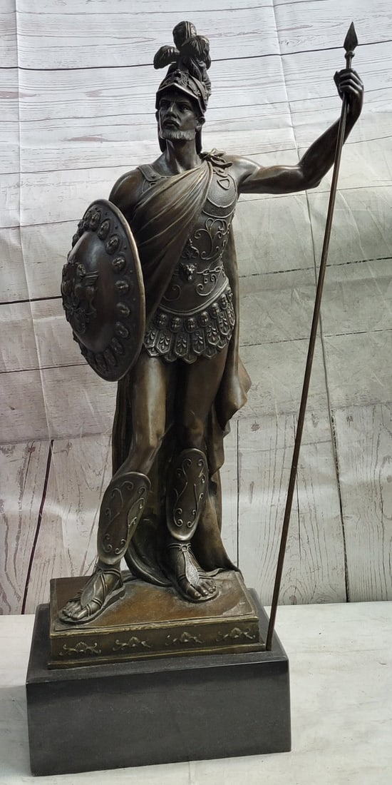 Roman Soldier Warrior Bronze Sculpture: The Roman knight stands proudly with his armor and weapons in hand. His confidence radiates in his comfortable stance and tense muscles. A long spear is in one hand and his shield in the other. He is