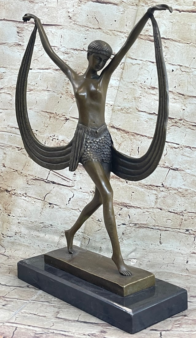 Dancer Bronze Figurine: The belly dancer is light on her feet and fluid with her waistline. She stretches her arms out to her sides as she glides across the floor on the balls of her feet. A long sash is attached to her