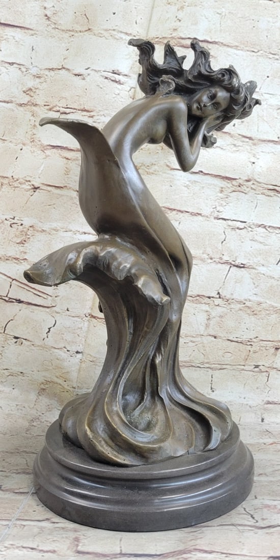Aquarius Lady Bronze Sculpture: A woman of the water. She and the water are one in this sculpture and actuality. She lives in the waves and deep below in the blue seas of the world. Her wavy hair and the water are the same shade of
