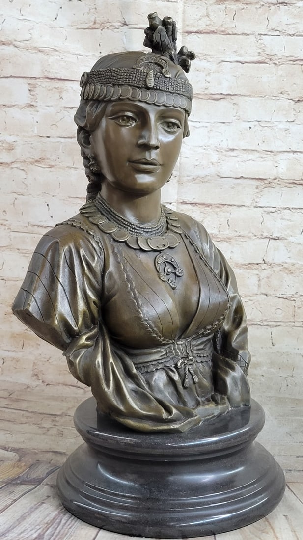 Egyptian Lady Bronze Sculpture: Egyptian lady with majestic expression wearing earrings of semi-precious stones, ornate jewelry and headdress, and long braids hanging down back. Cordier traveled to the far corners of the earth