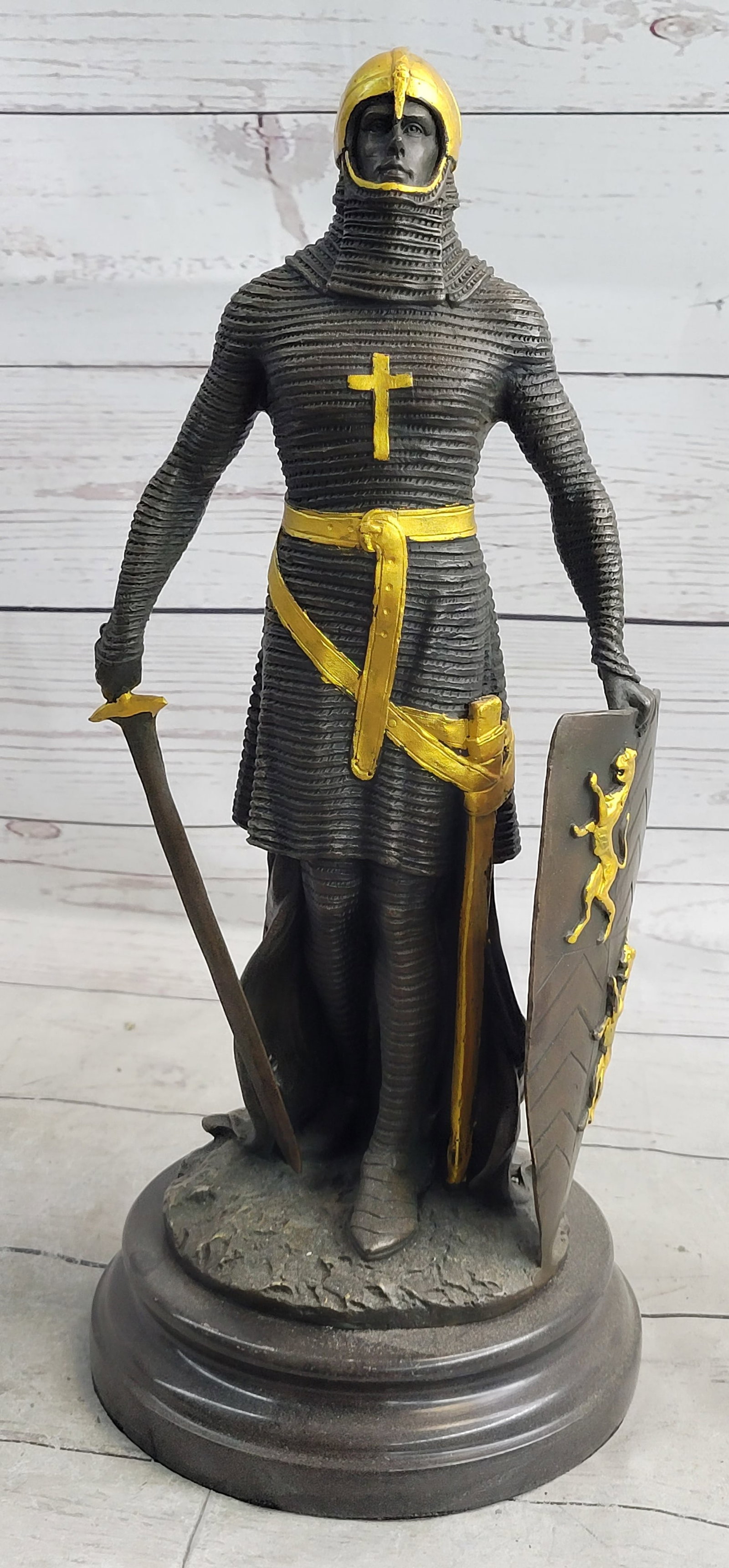 Knight Jousting Bronze Sculpture: The bold knight, in an attempt to seize his adversaries castle, wields his mighty sword in preparation for an attack. The full armor was created with great detail and accuracy. He was seen wearing a