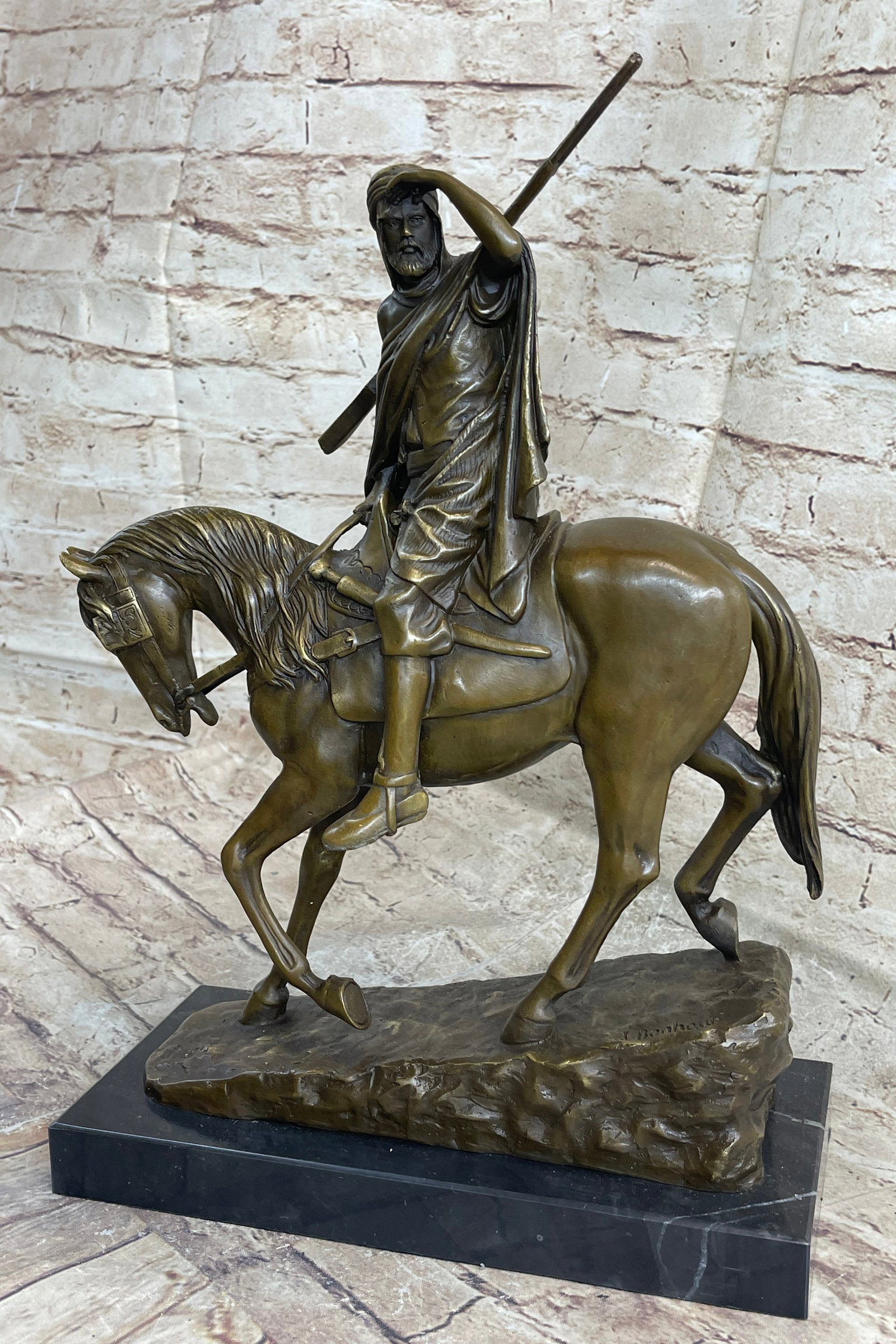 Arab Man on a Horse Bronze Sculpture: This sculpture features a man in traditional Arabian garb riding a horse through the desert searching for an oasis. He holds his hand up to shield the torturous sun as his eyes lose and find something