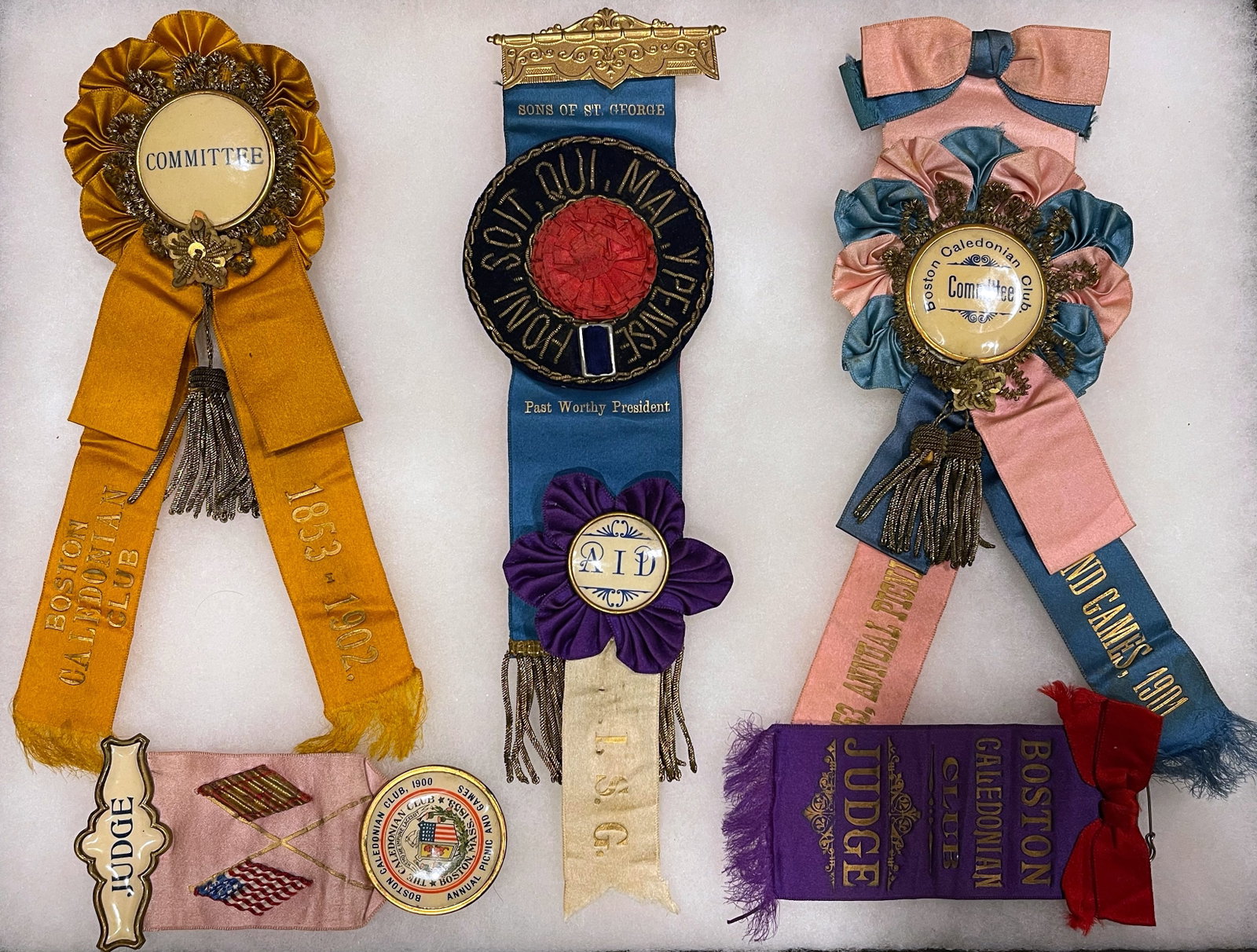 Antique Fraternal & Social Club Ribbon Badges ? Boston Caledonian Club & Sons of St. George (Early 1: A rare and attractive group of antique fraternal and social club ribbon badges dating to the late 19th and early 20th century. This lot includes beautifully preserved silk and satin ribbons associated