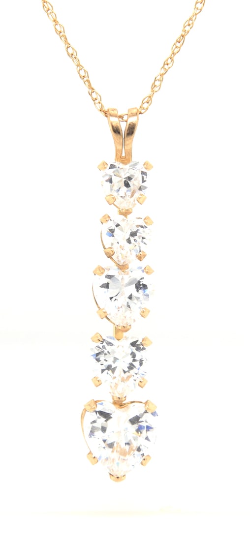 10kt Yellow gold heart shaped cubic zirconia pendant on chain necklace: 10kt Yellow gold heart shaped cubic zirconia pendant on 18 inches chain necklace. Total weight of necklace 1.9 grams.