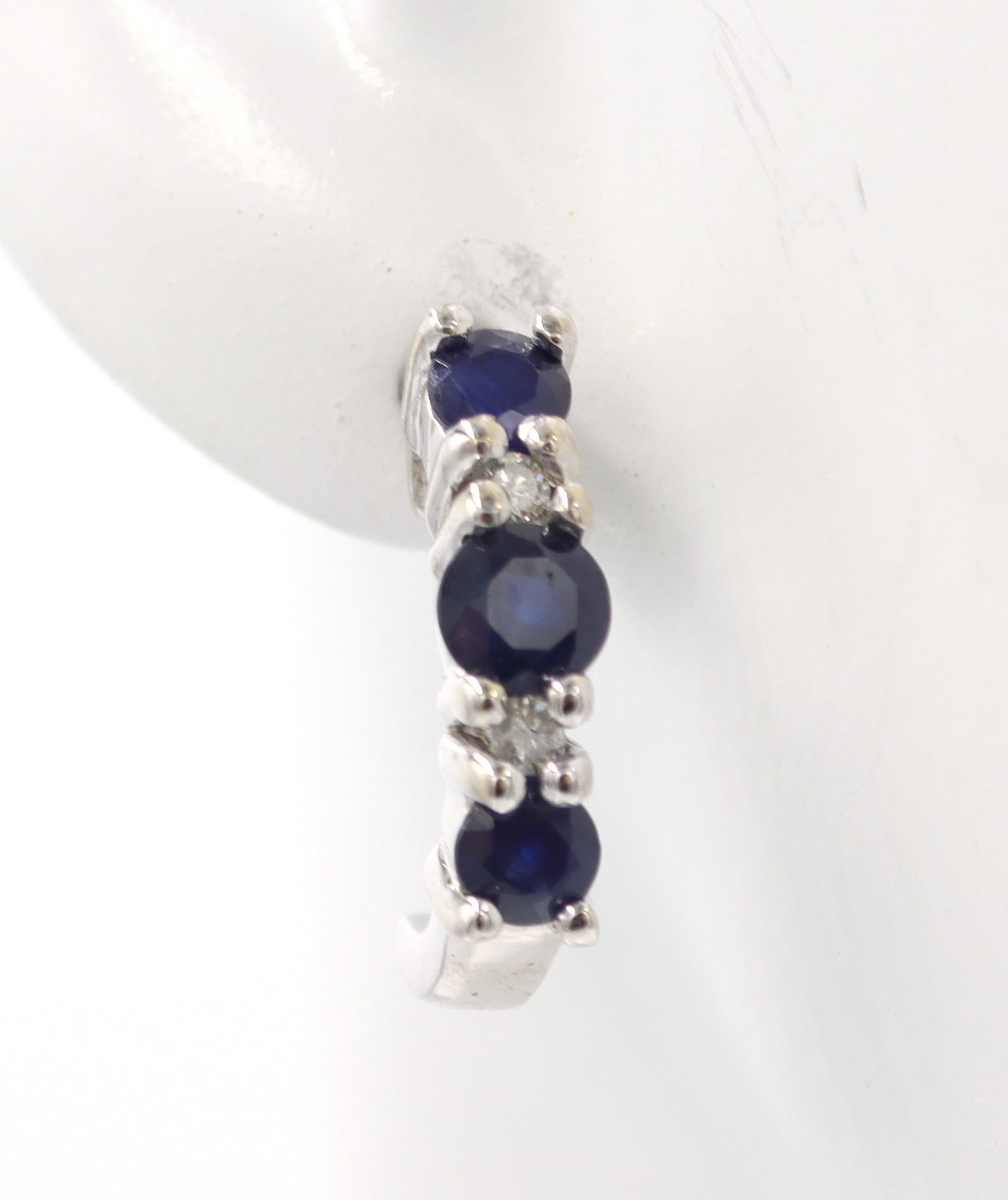 14kt White gold sapphire and diamond J hoops: 14kt White gold blue sapphire and diamond J hoops. Total weight of earrings is 2.89 grams.