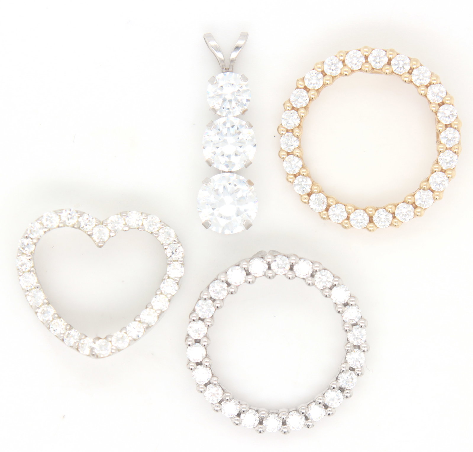 Group lot of 4 cubic zirconia pendants in 14kt: Group lot of 4 cubic zirconia pendants in 14kt. Total weight of lot is 6.8 grams.