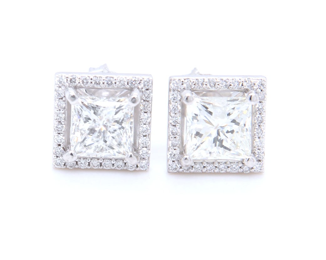 14kt White gold 2.13ctw princess cut diamond studs with halos: 14kt White gold approximate 2.13ctw princess cut diamond studs with halos. Color I-J. Clarity I. Total weight of earrings 1.40 grams.
