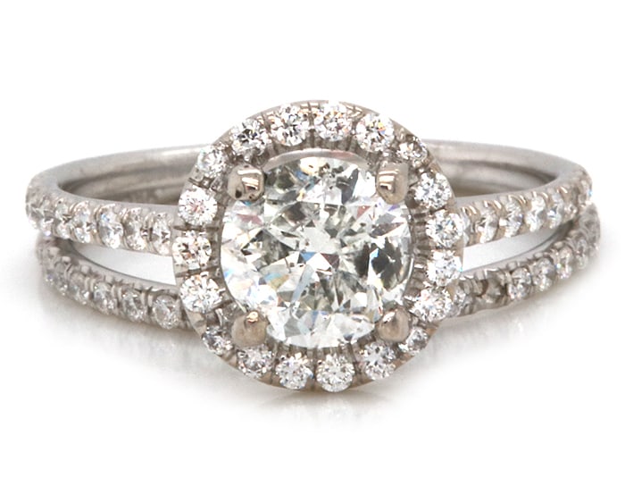 Spectacular 18kt WG Round Center Diamond with Halo Bridal Set: This Spectacular 18kt White Gold Bridal set features approx. 0.86CTW Round Brilliant Cut Center Diamond highlighted with approx. 0.43CTW Round Brilliant Cut Diamonds fashioned into a Halo Setting with