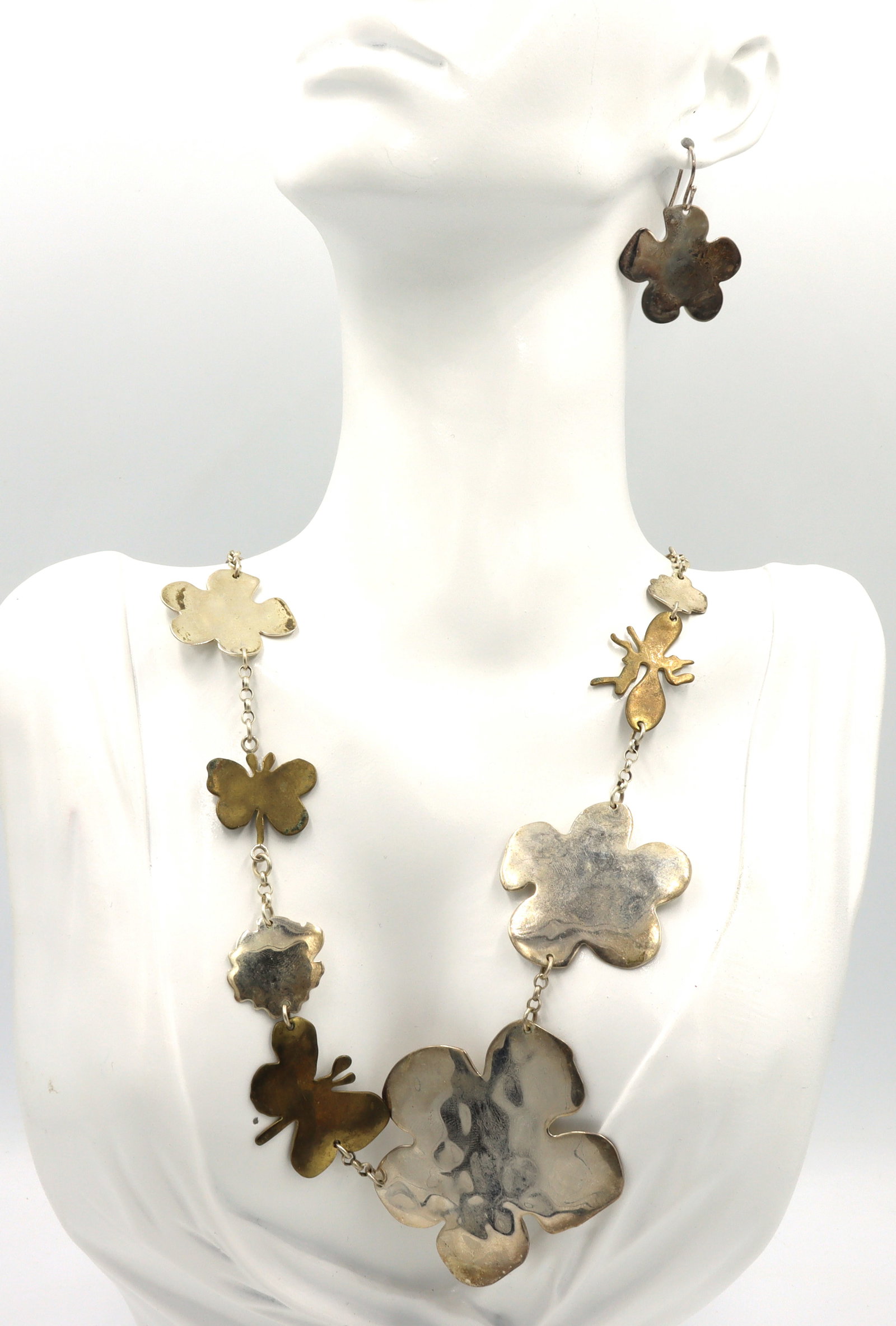 Set of Vintage 925 sterling silver necklace and dangle earrings: Set of signed Vintage 925 sterling silver butterfly and flower link 20-inch necklace and dangle earrings. The total weight of the lot is 48.9 grams.