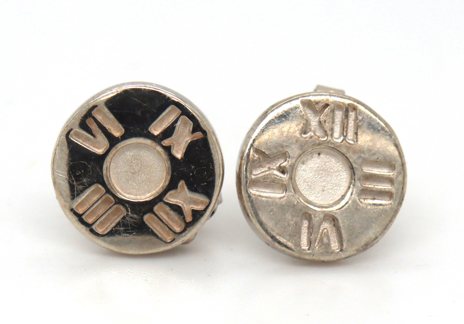 Tiffany & Co Atlas circle stud earrings: 925 Sterling silver Tiffany & Co Atlas circle stud earrings. The total weight of the earrings is 2.70 grams.