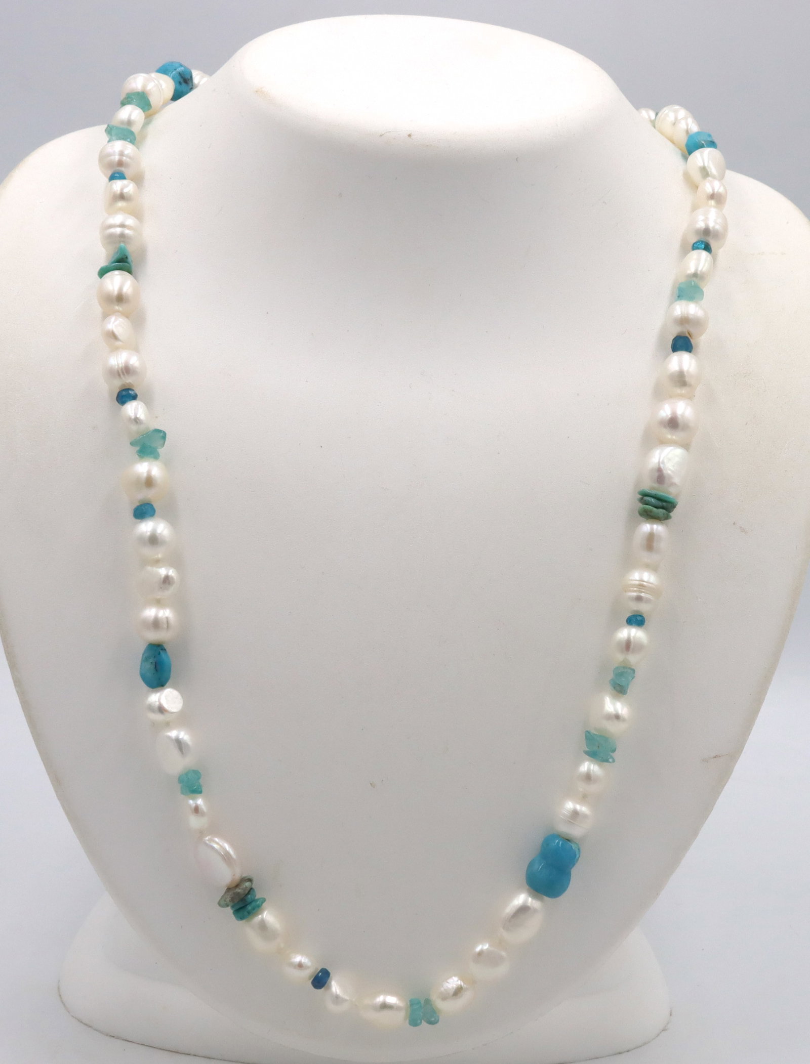 Pearl and turquoise strand necklace: Pearl and turquoise 40-inch strand necklace with 925 sterling silver clasp. The total weight of the necklace is 76.9 grams.