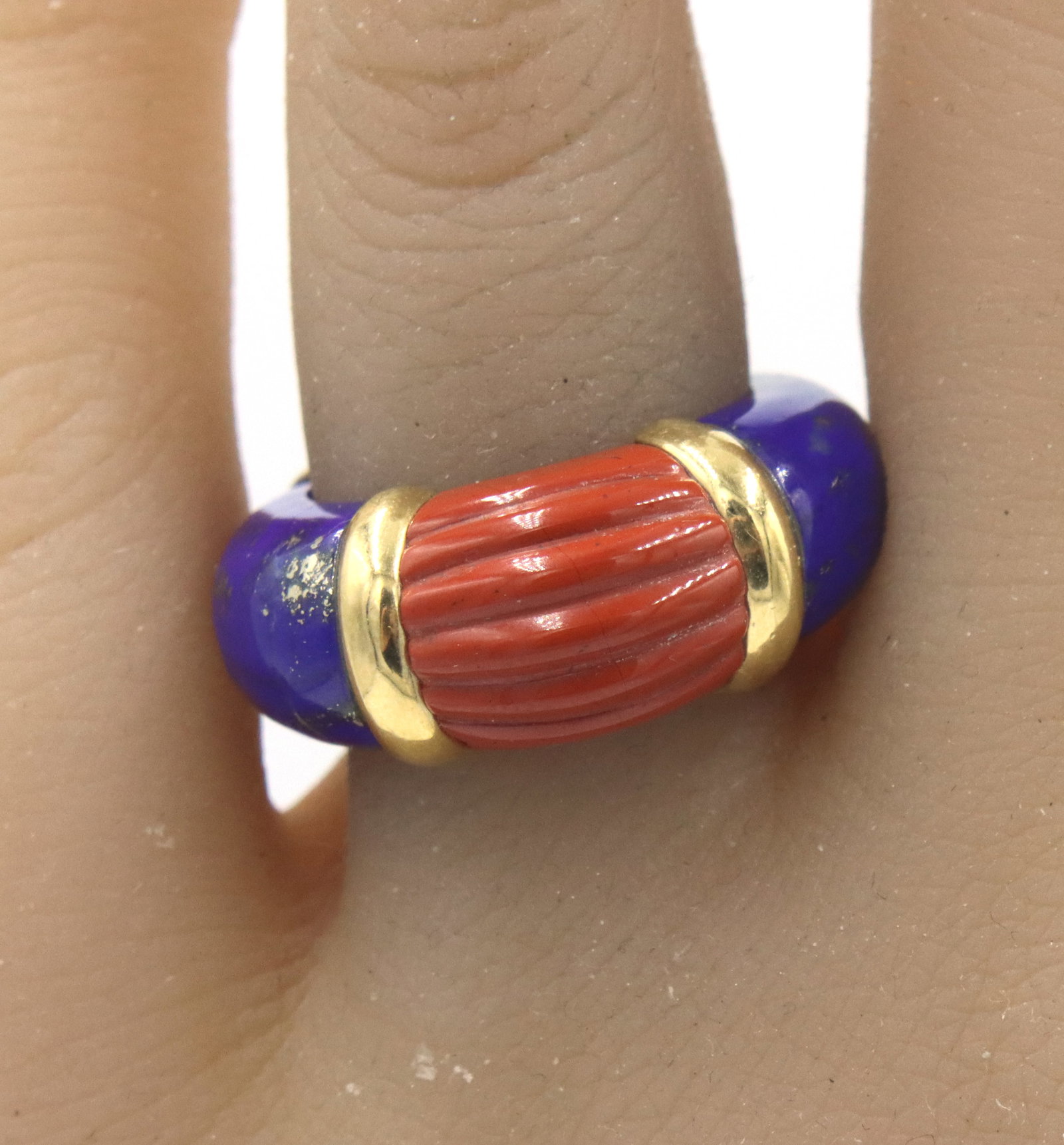 14kt Yellow gold Lapis and Coral ring: 14kt Yellow gold Lapis and Coral ring. The total weight of the ring is 7.3 grams. Ring size 5".