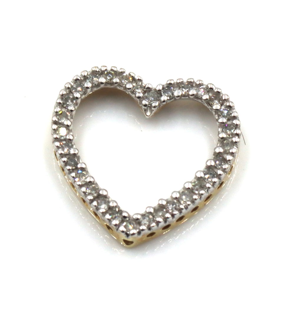 10kt Yellow gold diamond heart shaped pendant: 10kt Yellow gold diamond heart shaped pendant. The total weight of the pendant is 1.2 grams.