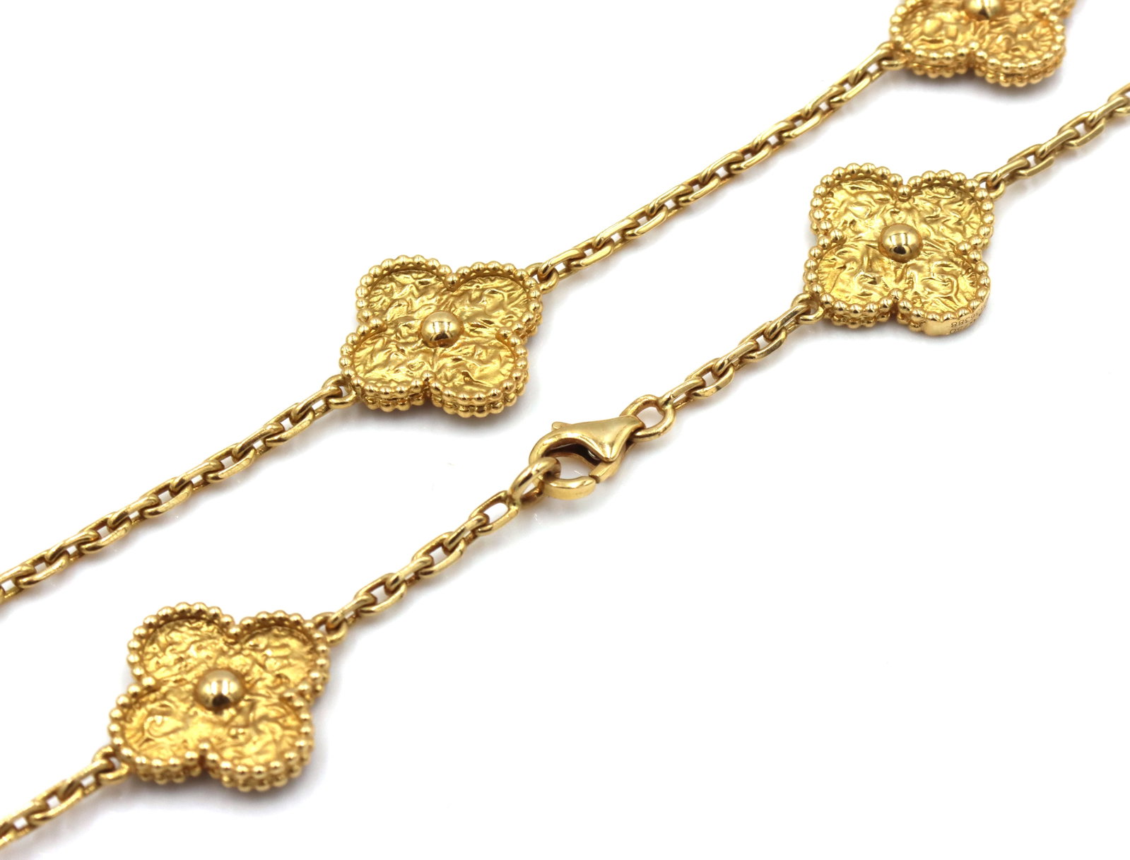 18kt Yellow gold 10 clover motif necklace: 18kt Yellow gold 10 clover motif 18-inch necklace with lobster clasp. The total weight of the necklace is 29.5 grams. (Designer inspired, not designer)