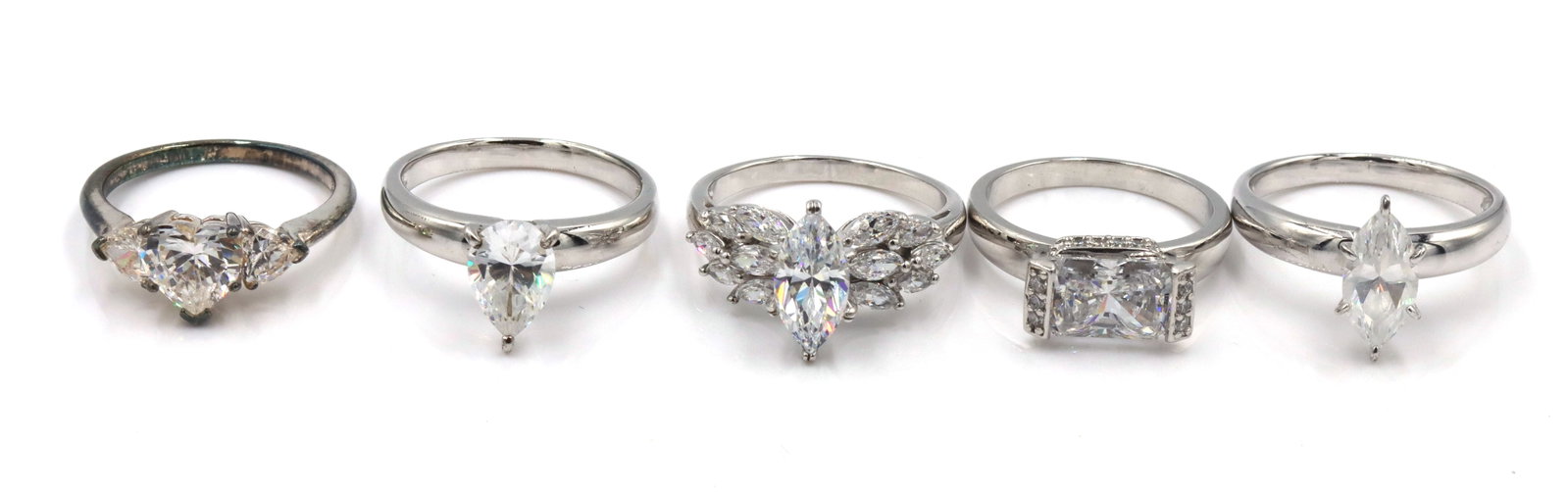 Group lot of 5 925 sterling silver cubic zirconia rings: Group lot of 5 925 sterling silver cubic zirconia rings. The total weight of the lot is 25.3 grams. Ring size 9.25",10.25", 9",10.5".