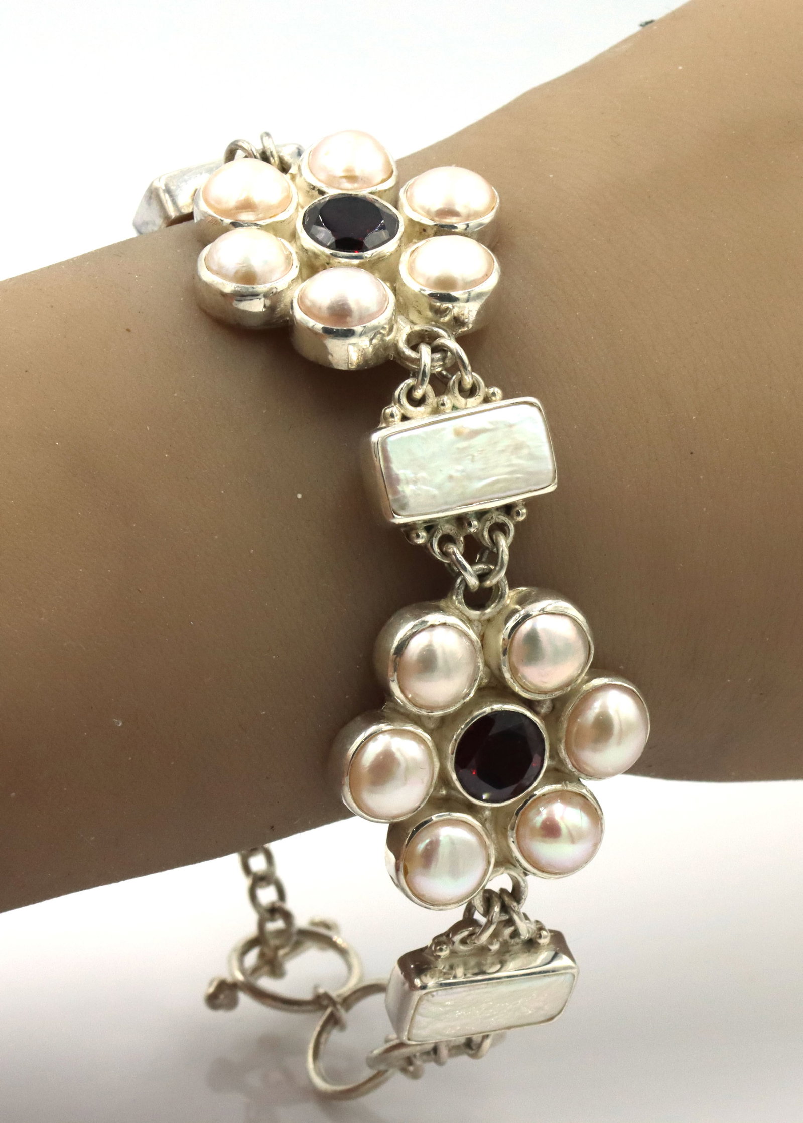 925 Sterling silver Sejan signed pearl flower style link toggle bracelet: 925 Sterling silver Sejan signed pearl flower style link toggle 8-inch bracelet. Missing one stone. The total weight of the bracelet is 48.6 grams.