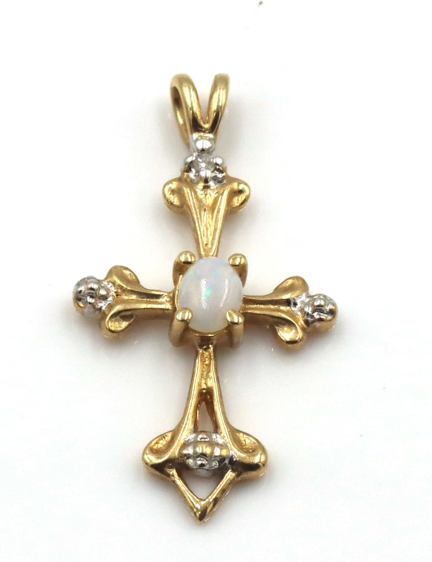 14kt Yellow gold opal cross pendant: 14kt Yellow gold opal cross pendant. The total weight of the pendant is 1.1 grams.