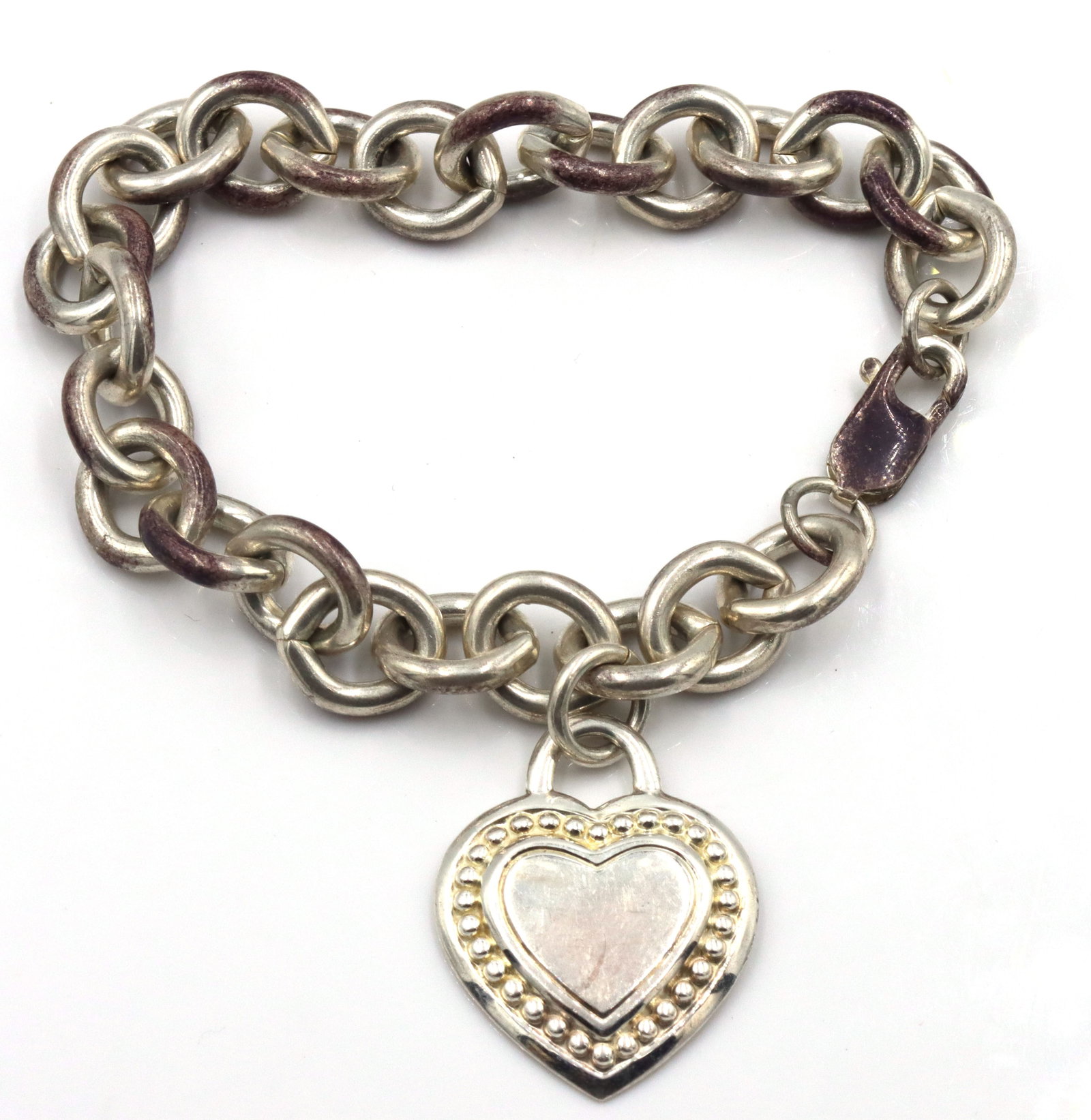 Judith Ripka Link Bracelet With Heart Charm: Judit Ripka oval link chain bracelet with heart charm. 49.7 G