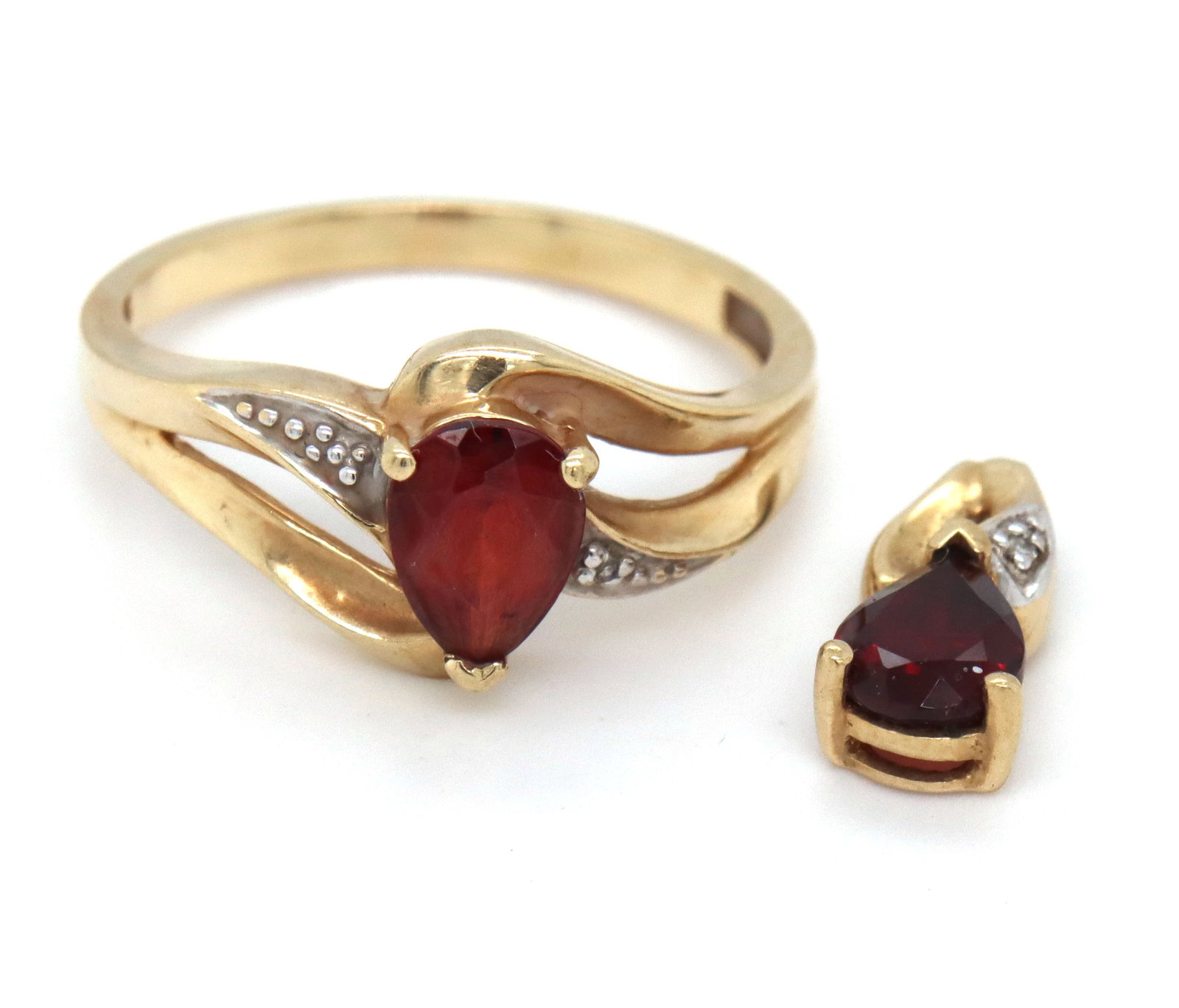 Set of 10kt yellow gold garnet ring and pendant: Set of 10kt yellow gold pear shaped garnet ring and pendant. The total weight of the set is 2.7 grams.
