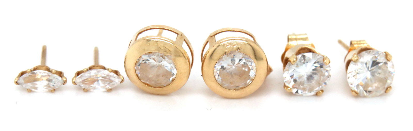 3 Pairs of 14kt yellow gold CZ stud earrings: 3 Pairs of 14kt yellow gold Cubic Zirconia stud earrings. The total weight of the lot is 2.7 grams.