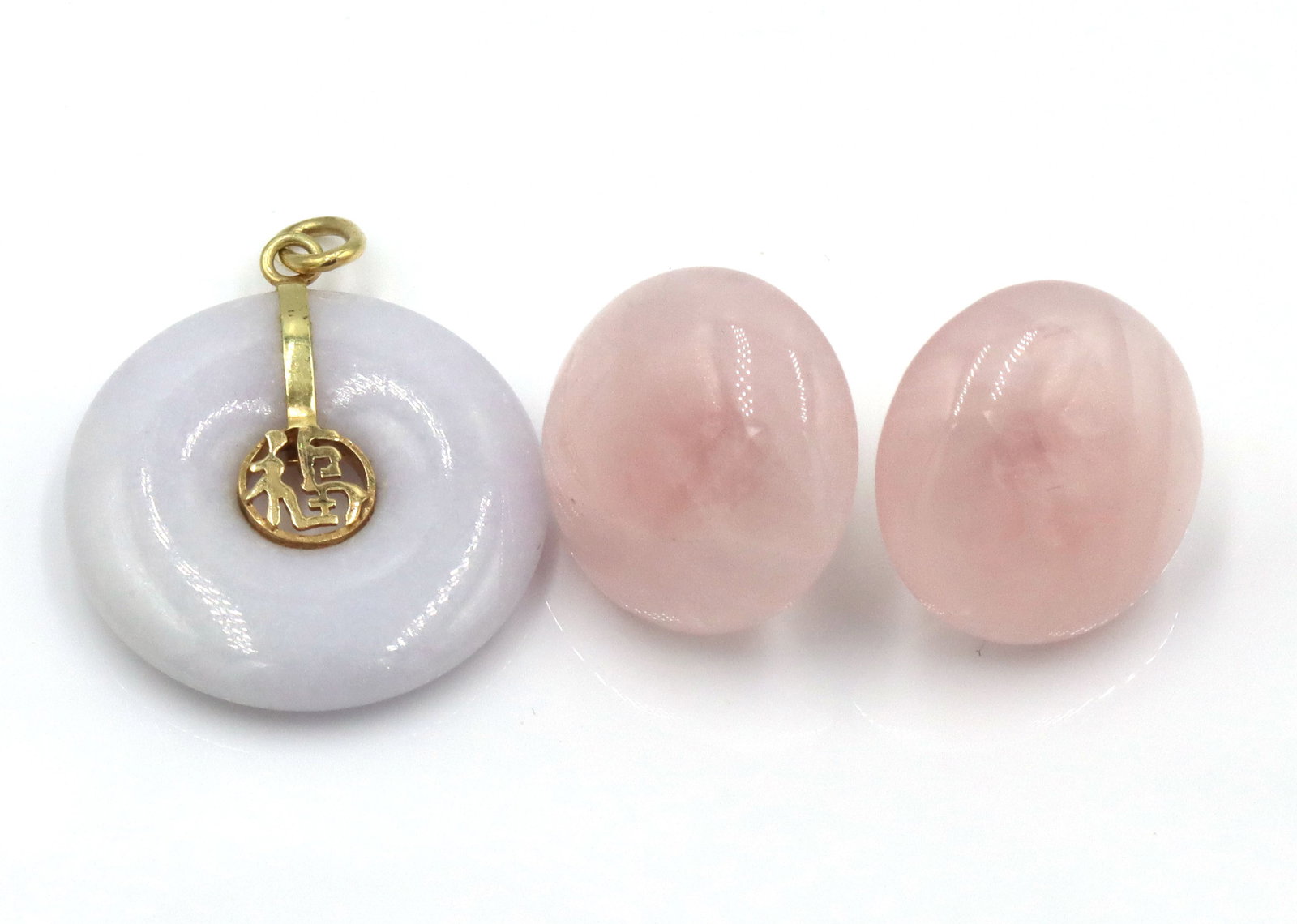 Set of 14kt yellow gold Jade stud earrings and pendant: Set of 14kt yellow gold pink Jade stud earrings and purple Jade pendant. The total weight of the set is 7.9 grams.