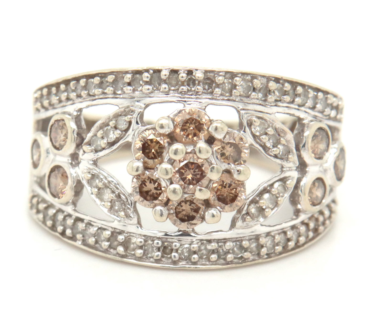 10kt White gold champagne and white diamond band: 10kt White gold champagne and white diamond band. The total weight of the ring is 4.5 grams. Ring size 7".