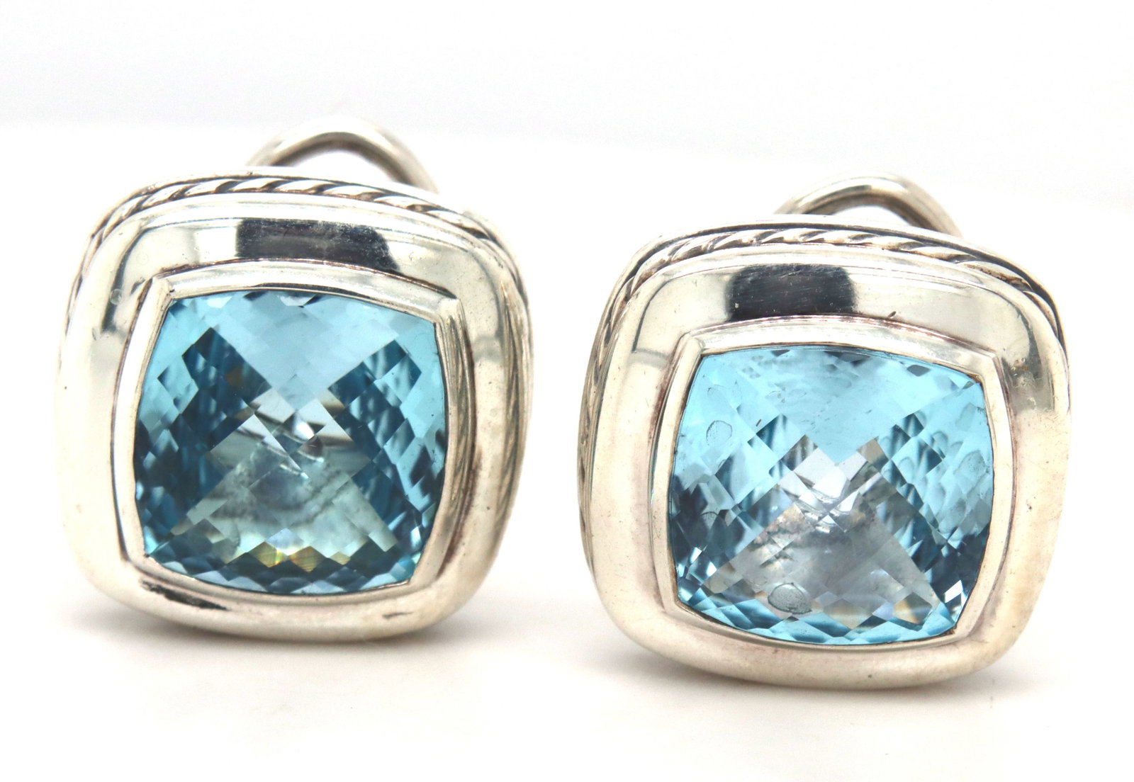 David Yurman Cable classic blue topaz omega earrings: David Yurman Cable classic blue topaz omega earrings in 925 sterling silver. The total weight of the earrings is 11.10 grams.