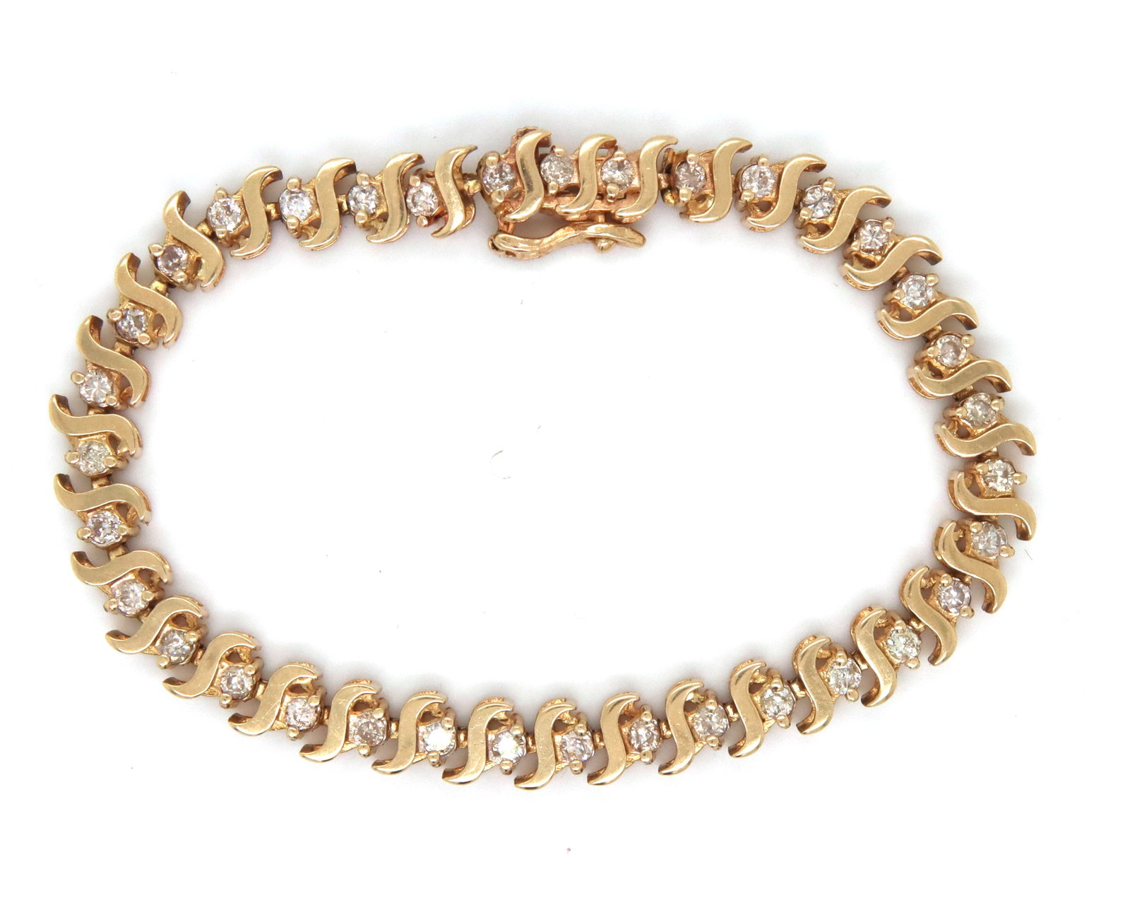 14kt Yellow gold round brilliant cut diamond S link bracelet: 14kt Yellow gold round brilliant cut diamond S link 6.75-inch bracelet. The total weight of the bracelet is 13.9 grams.