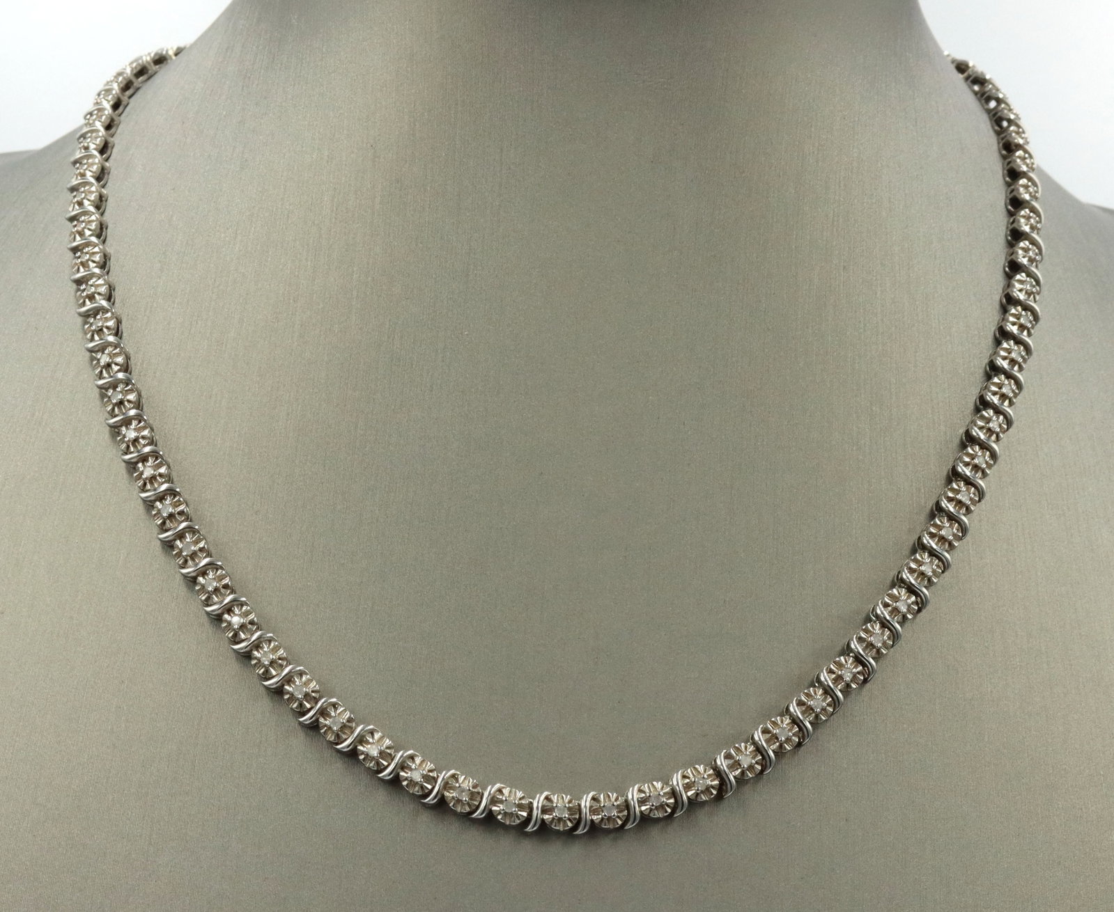 925 Sterling silver cubic zirconia link chain necklace: 925 Sterling silver cubic zirconia link 17-inch chain necklace. The total weight of the necklace is 24 grams.