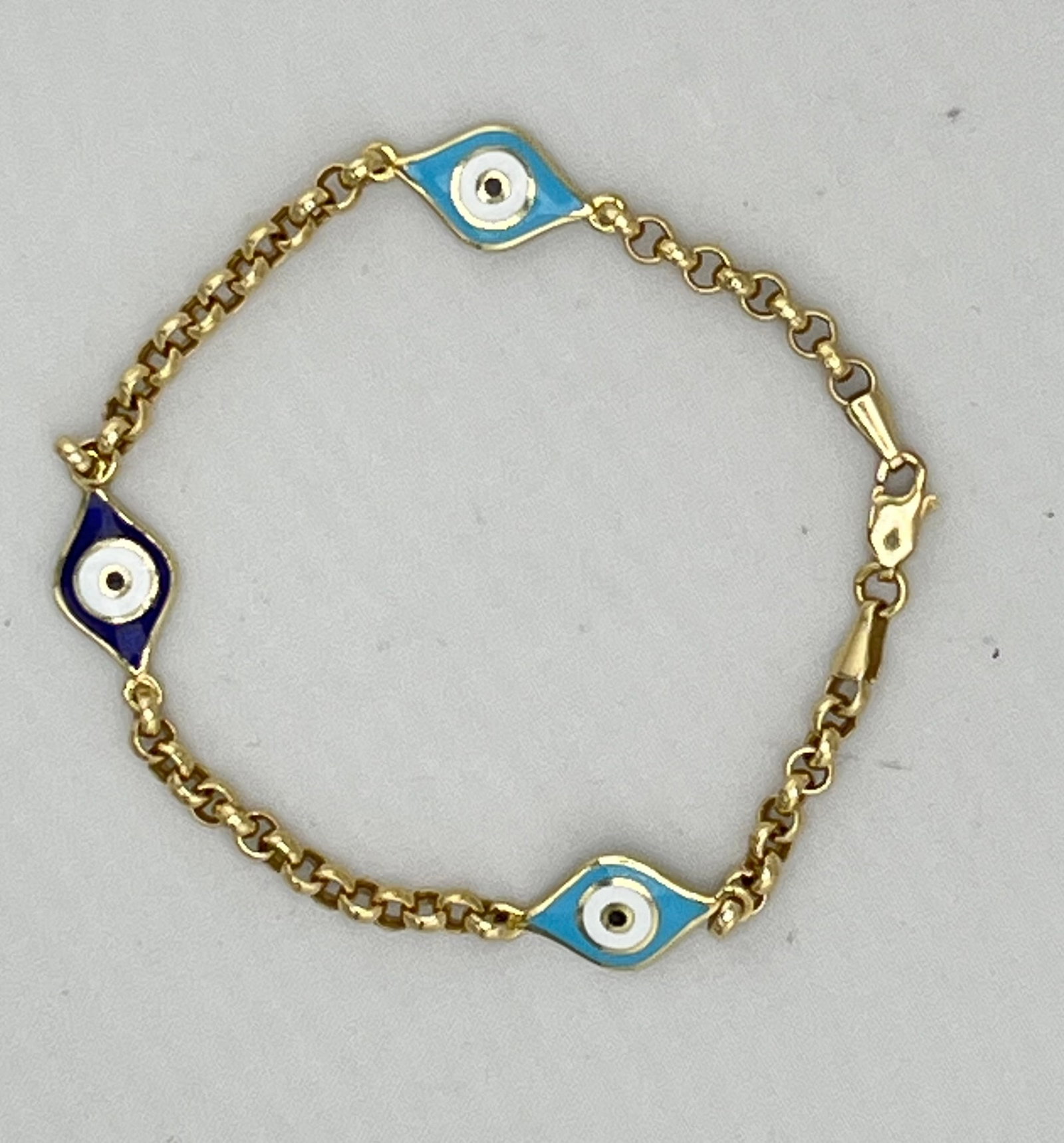 14KT Yellow Gold Two Different Enamel Color Evil Eye With Rolo link Chain: 14KT Yellow Gold hand made Can Be Worn On Two Sides With Different Color Enamel Turquoise & Lapis Evil Eye Bracelet. 8 grams . 8 inches