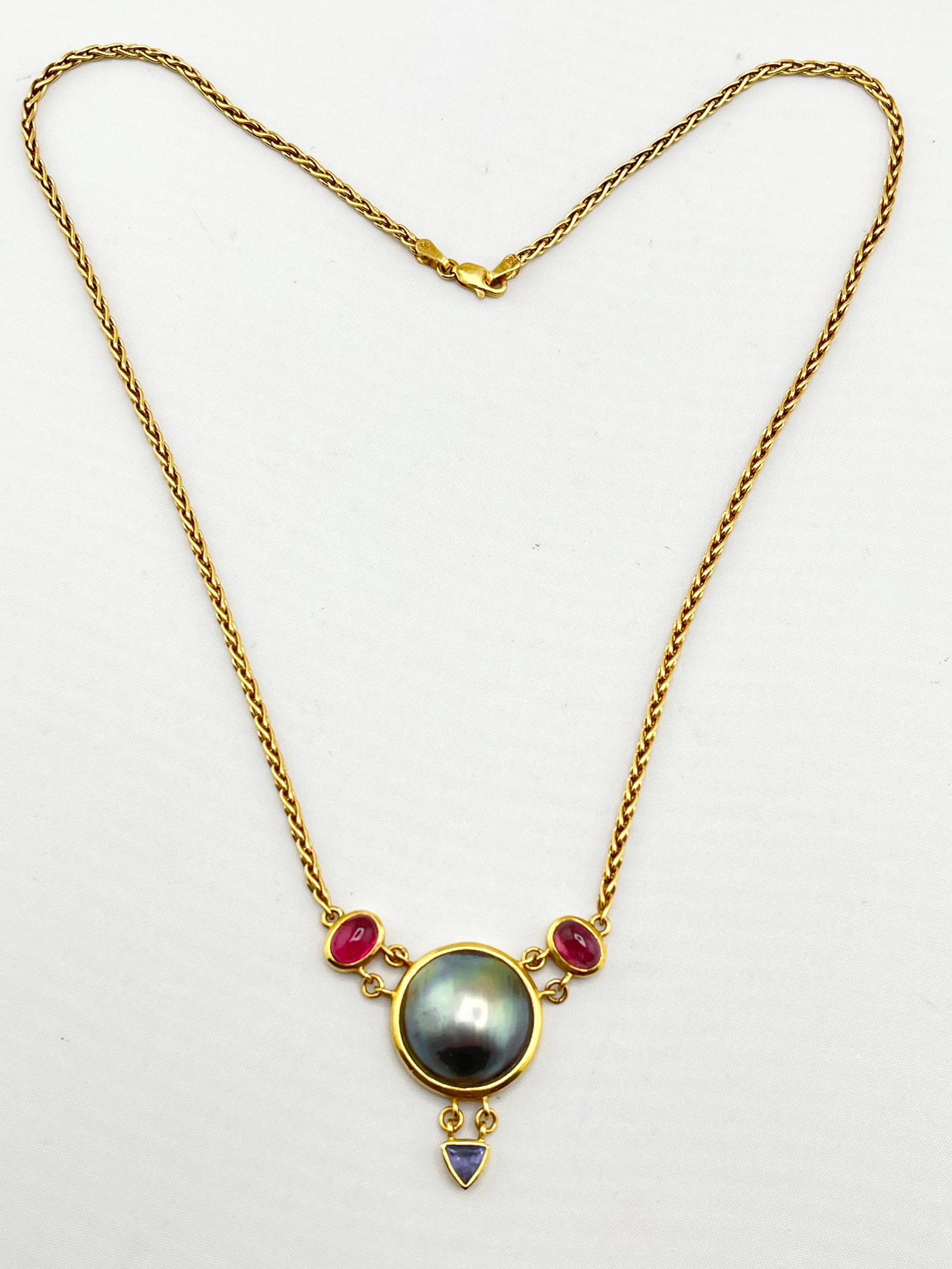 18KT Yellow Gold Center Round Gray Pearl Flanked By Two Oval Pink Tourmaline And Blue Topaz Dangling: 18KT Yellow Gold Round Gray Pearl Flanked By Two Oval Pink Tourmaline And Blue Topaz Dangling With Beautiful Solid Wheat Chain. 17.8 grams, 18 inches