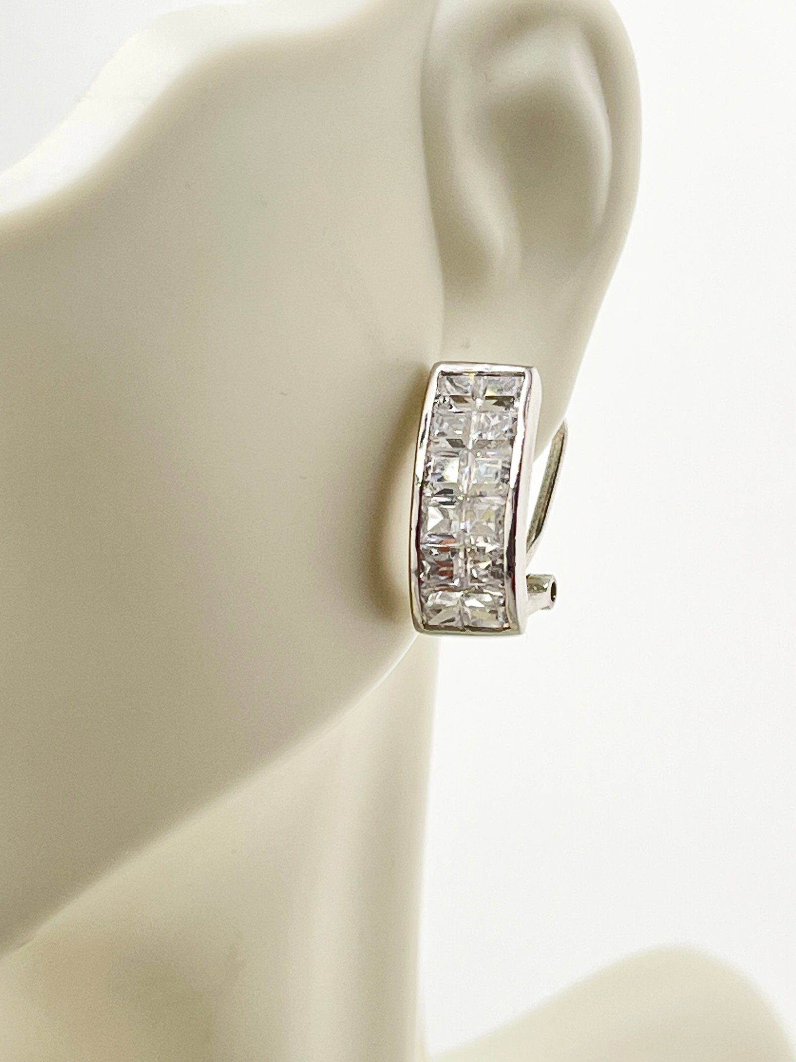 925 Sterling Silver Baguette Cut CZ Oval Hoop Earrings: 925 Sterling Silver Bugguette Cut CZ Oval Hoop Earrings With Omega Clip Closure. 7 Grams. 3/4 inch