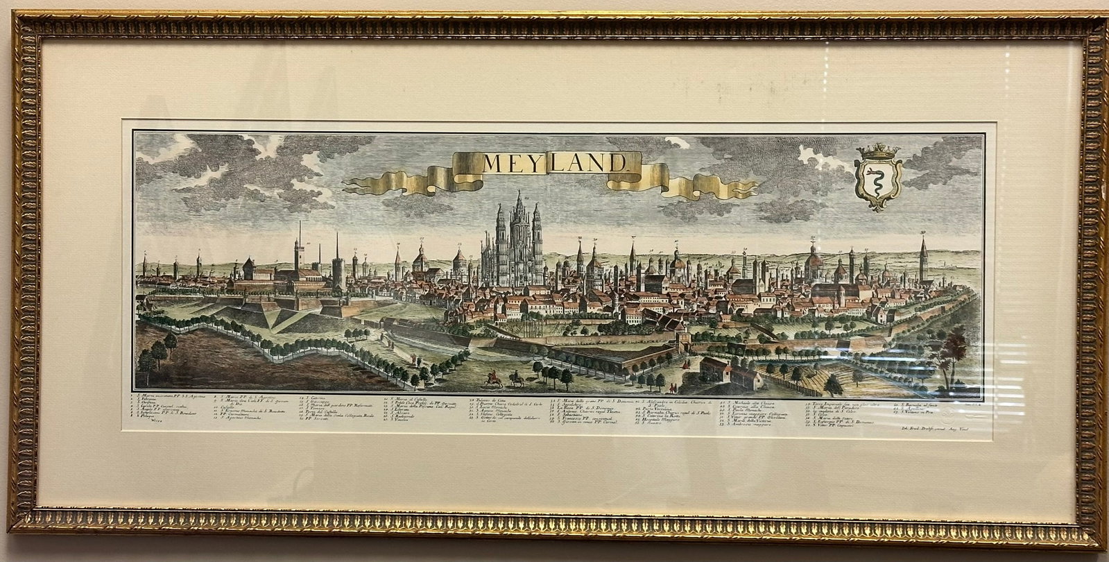 Antique ?MEYLAND? Panoramic City View Engraving Hand Colored European Landscape Print, Framed: Antique-style panoramic engraving titled ?MEYLAND,? depicting an expansive, highly detailed European cityscape. This horizontal composition showcases fortified walls, cathedral architecture, towers,