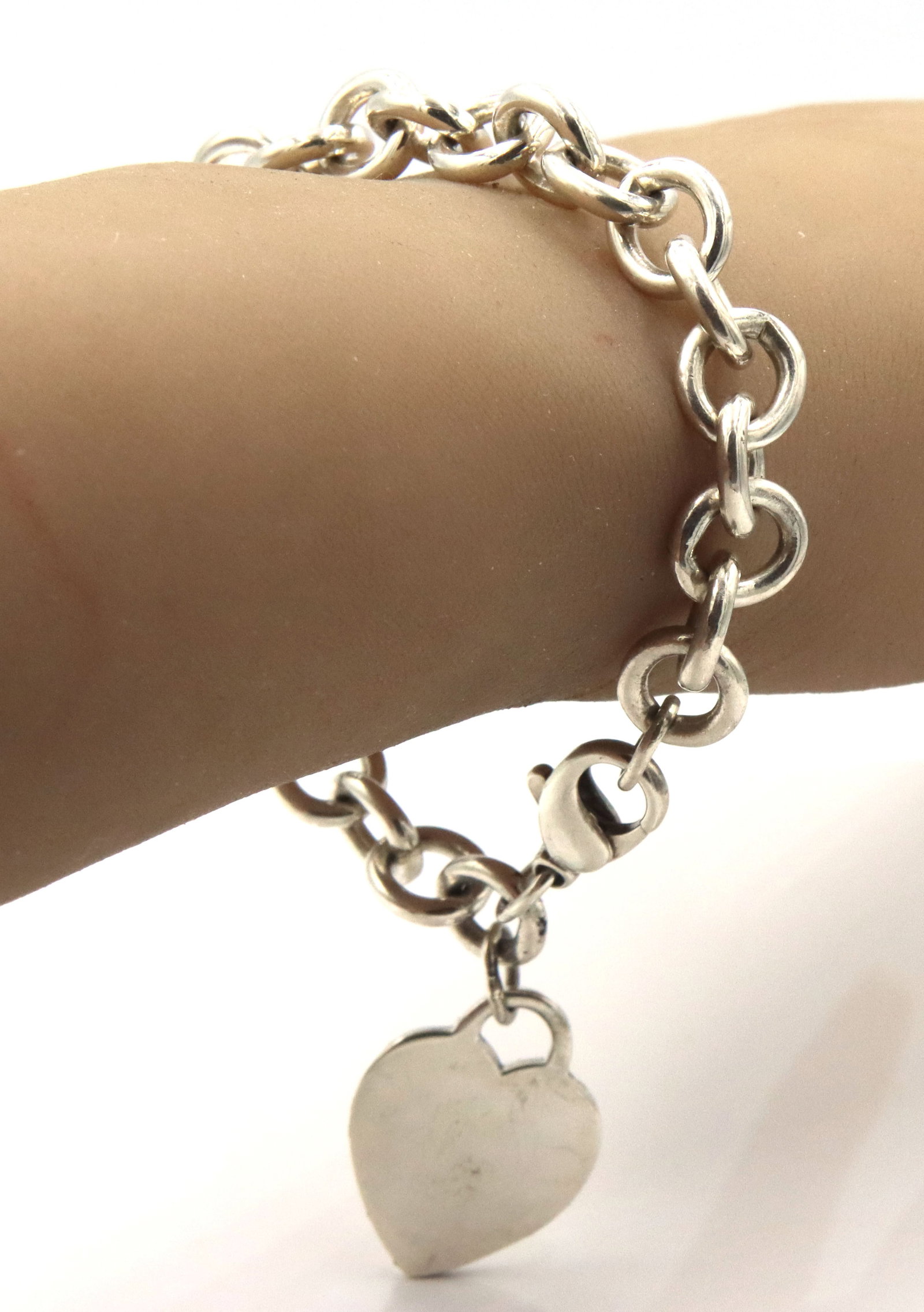 Tiffany & co heart tag charm bracelet: Tiffany & co heart tag charm 7-inch bracelet in 925 sterling silver. The total weight of the bracelet is 36 grams.