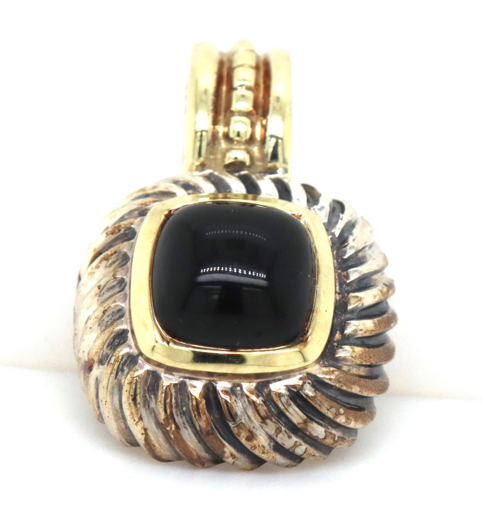 David Yurman black onyx pendant: David Yurman black onyx pendant in 925 sterling silver. The total weight of the pendant is 5.30 grams.